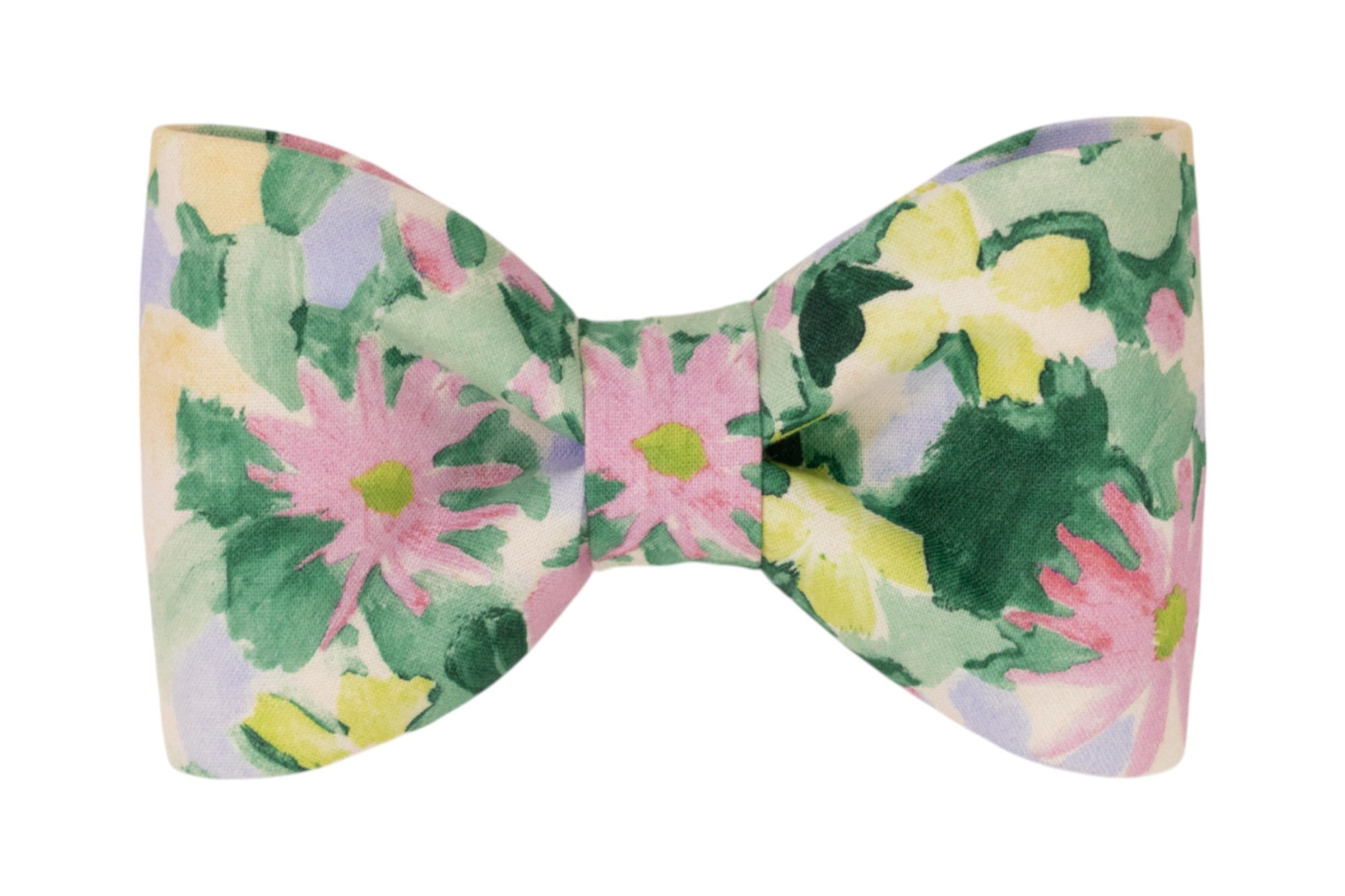 A dog bow tie made of fabric with a watercolor-style floral pattern in pastel pink, green, yellow, and lavender hues.