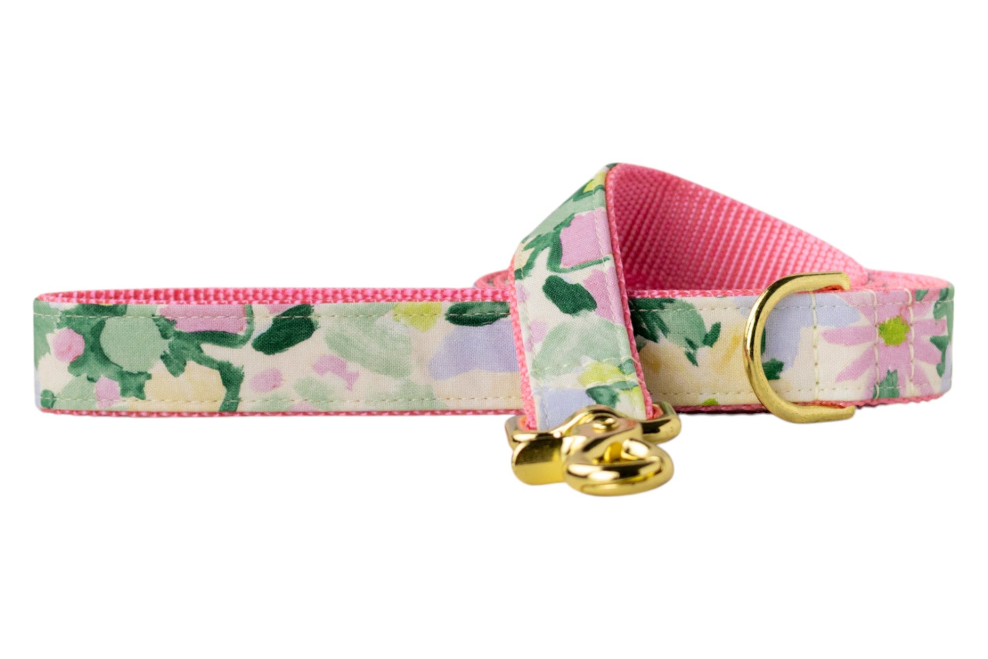 A floral dog leash with soft watercolor-style flower prints in pink, green, yellow, and lavender. It features pink woven webbing and gold-tone metal hardware.
