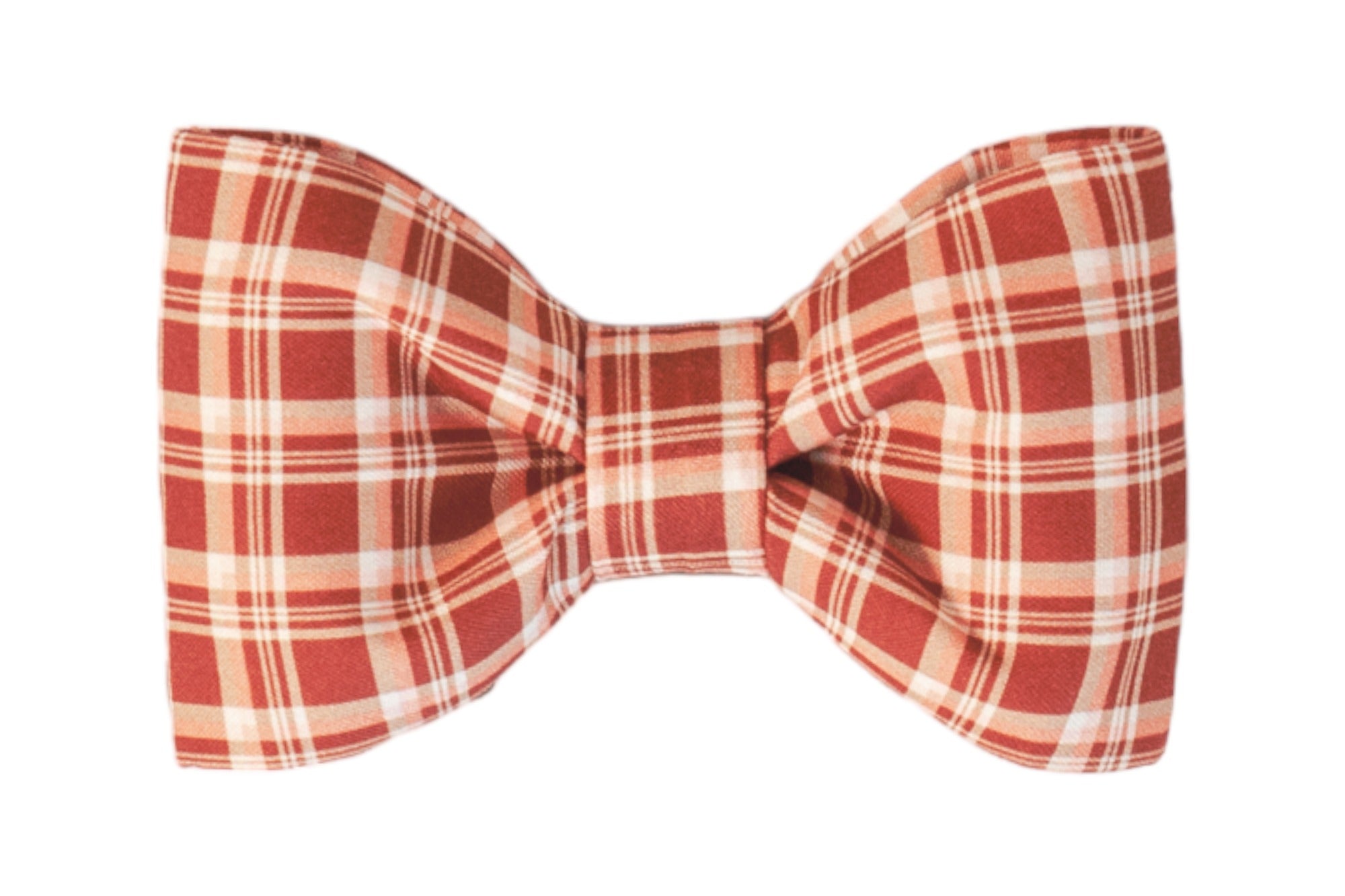 A symmetrical, fabric bow tie made of soft cotton in a red plaid pattern, featuring evenly spaced stripes. The bow tie is neatly pleated at the center, creating a structured yet slightly puffy shape.