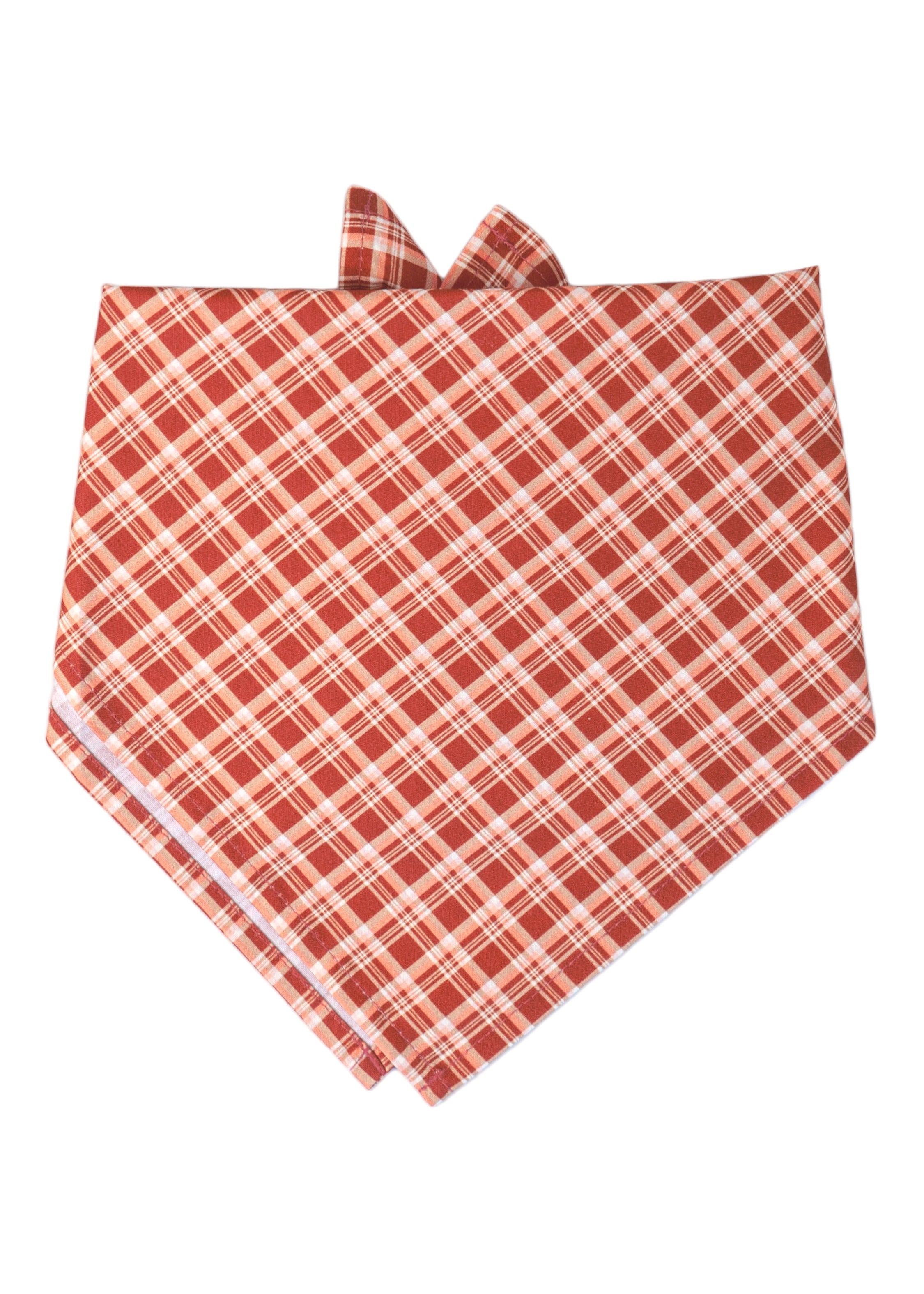 Dog bandana in a diagonal red plaid pattern, tied at the top for easy wear. The perfect addition to your pups fall wardrobe.