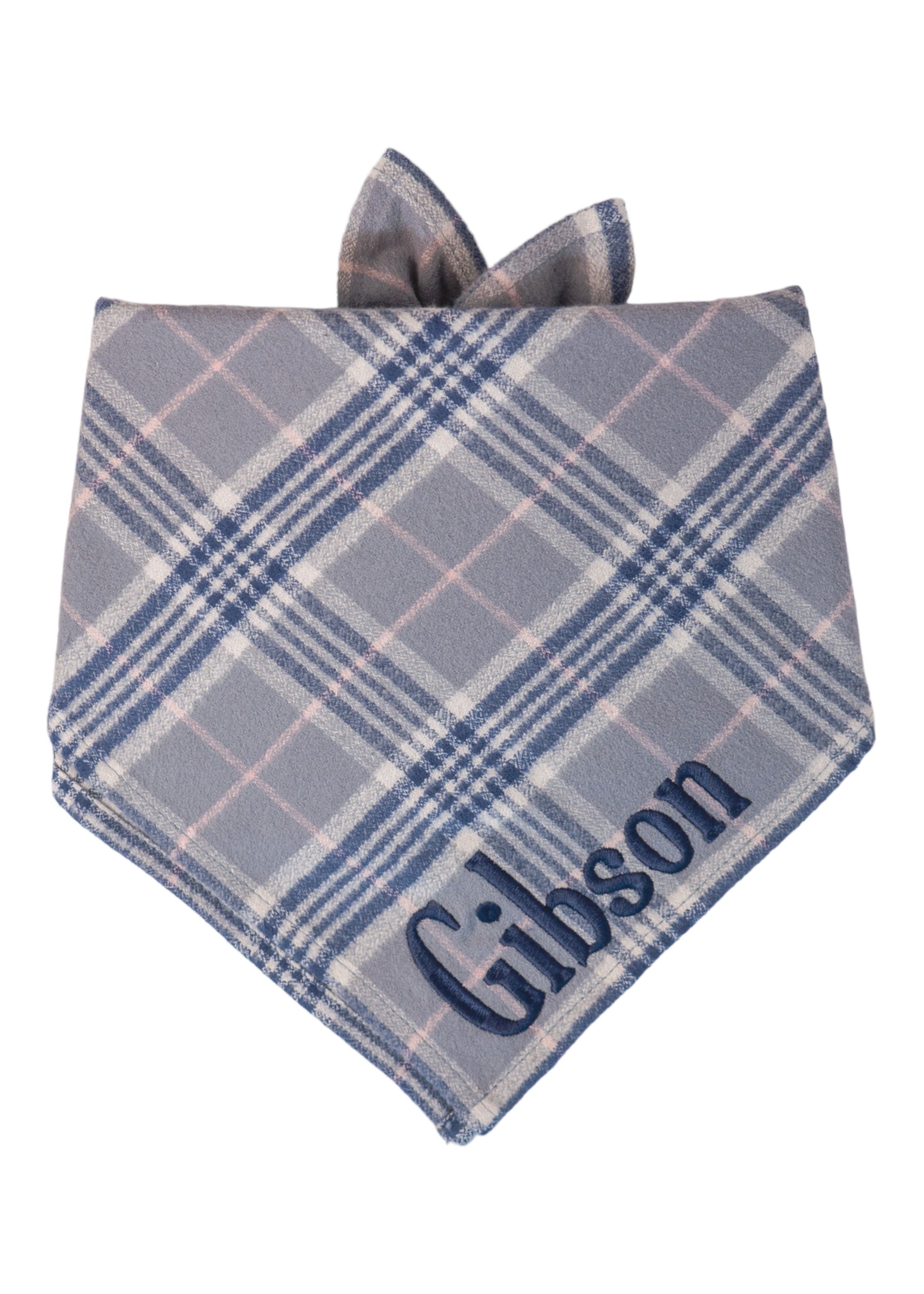 Personalized flannel dog bandana in grey, tartan pattern, featuring embroidered name "Gibson" in bold letters.