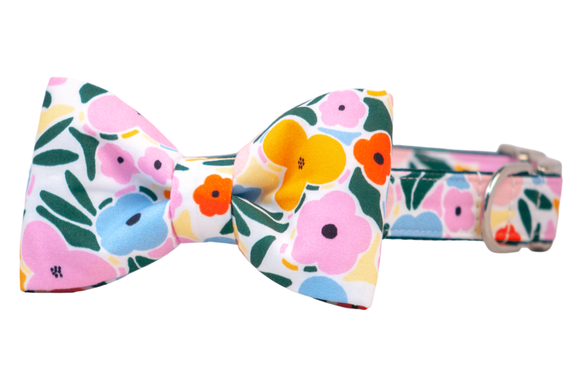 A colorful dog collar with an attached bow tie, both made from fabric featuring a vibrant floral print in shades of pink, yellow, orange, blue, and green. The collar includes a metal D-ring and buckle, and the structured bow is centered neatly for a playful, polished look.