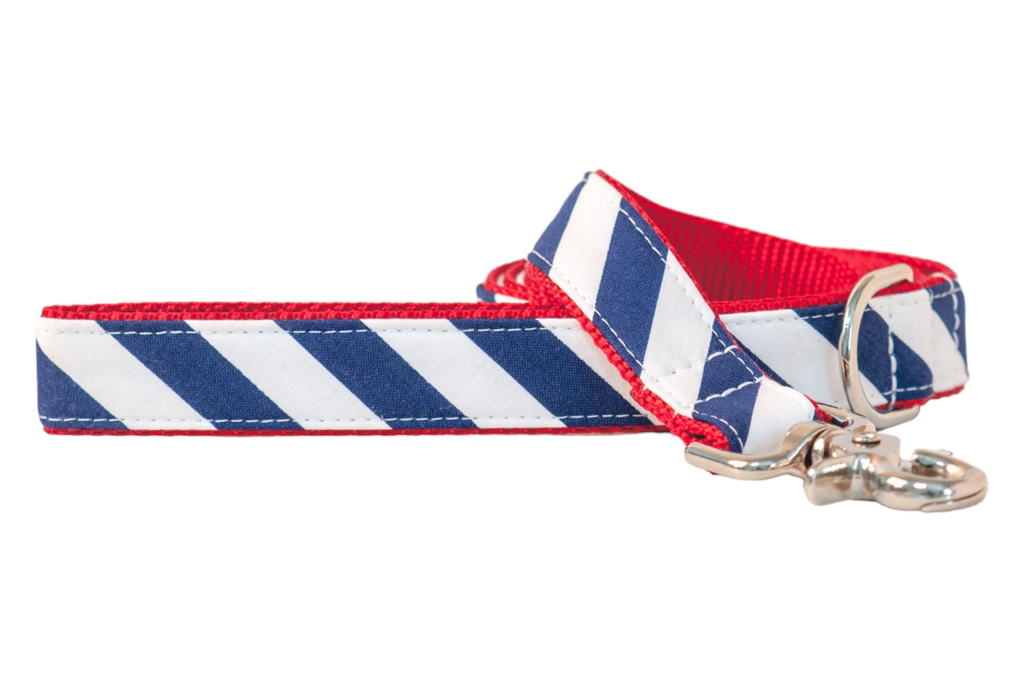 Patriotic-themed dog leash with blue and white diagonal stripe fabric, red webbing for backing, and a silver clip for attaching to a collar.