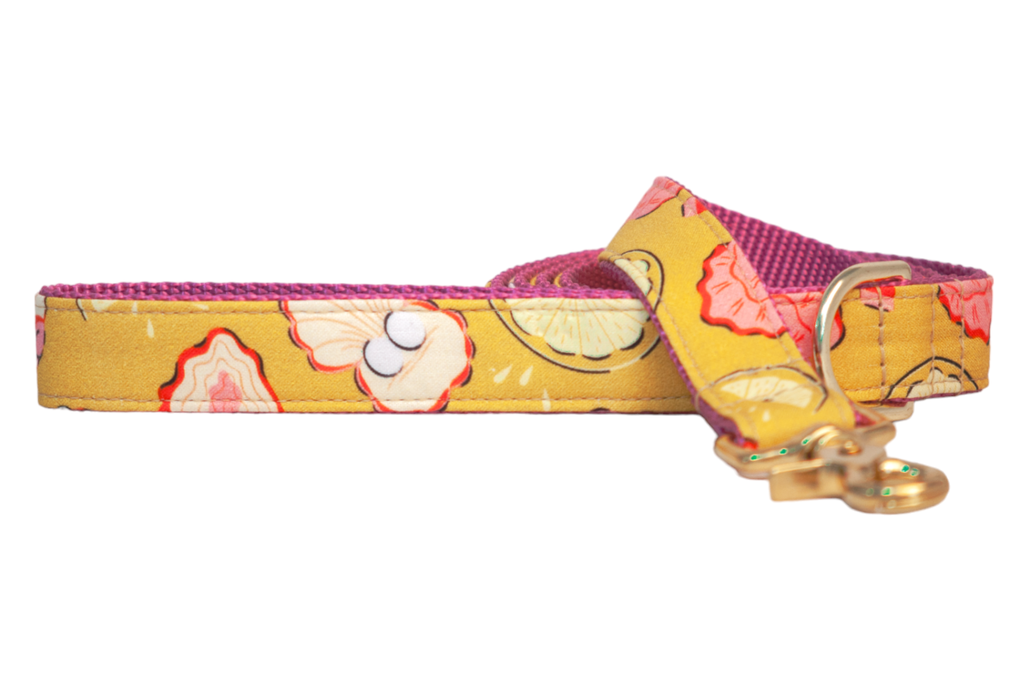 A vibrant yellow dog leash featuring a playful pattern of lemon slices, pink and cream oysters with red accents. The leash has a durable pink underside and is finished with gold swivel snap hook and D-ring.