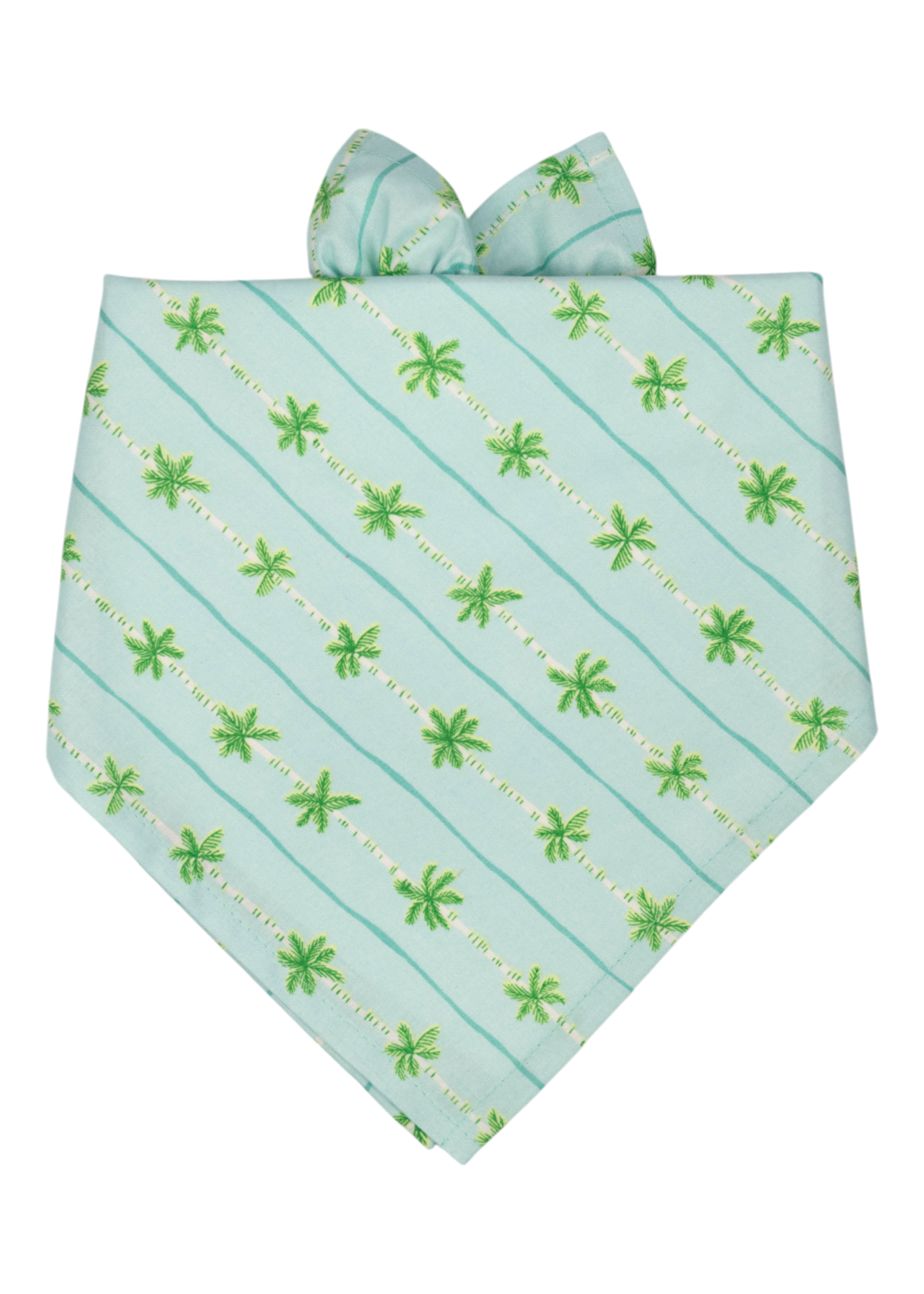 A light aqua blue dog bandana with diagonal green and tan palm trees and subtle aqua blue stripe accents, tied at the top in a simple knot.