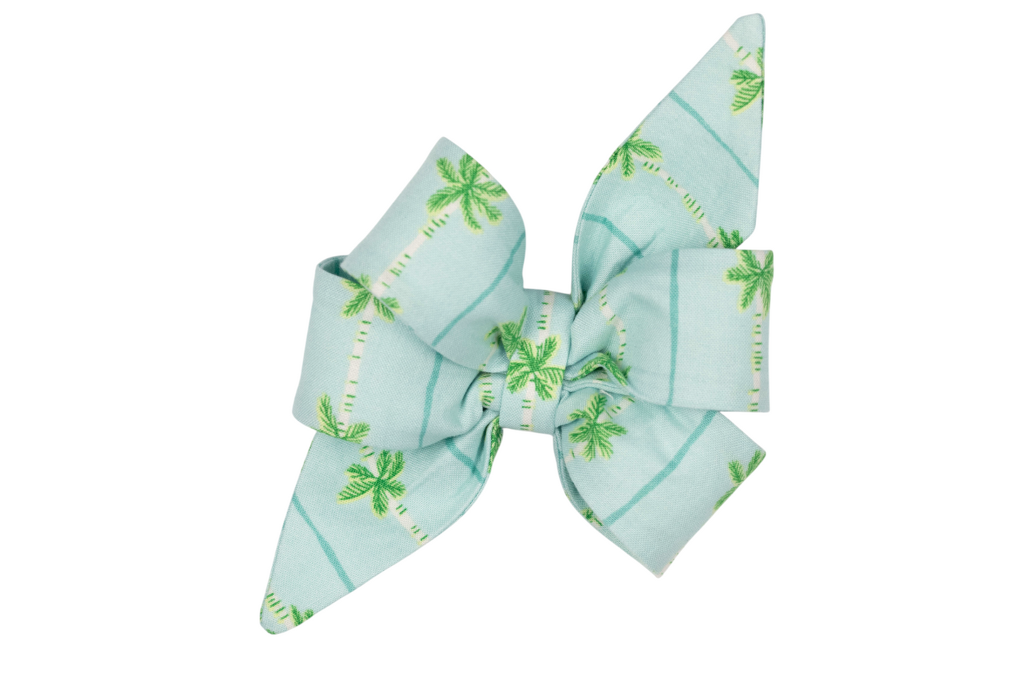 Tropical-style girl dog belle bow in pastel aqua blue, featuring a green palm tree and blue stripe pattern with long pointed ends and layered folds.