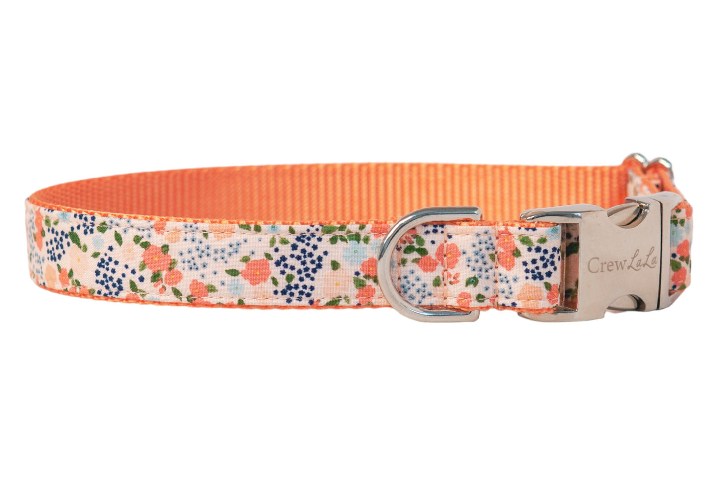 Stylish floral dog collar with peach and pink blooms scattered among leaves, contrasted by vivid peach nylon lining, and secured with metal hardware engraved with the brand name Crewlala.