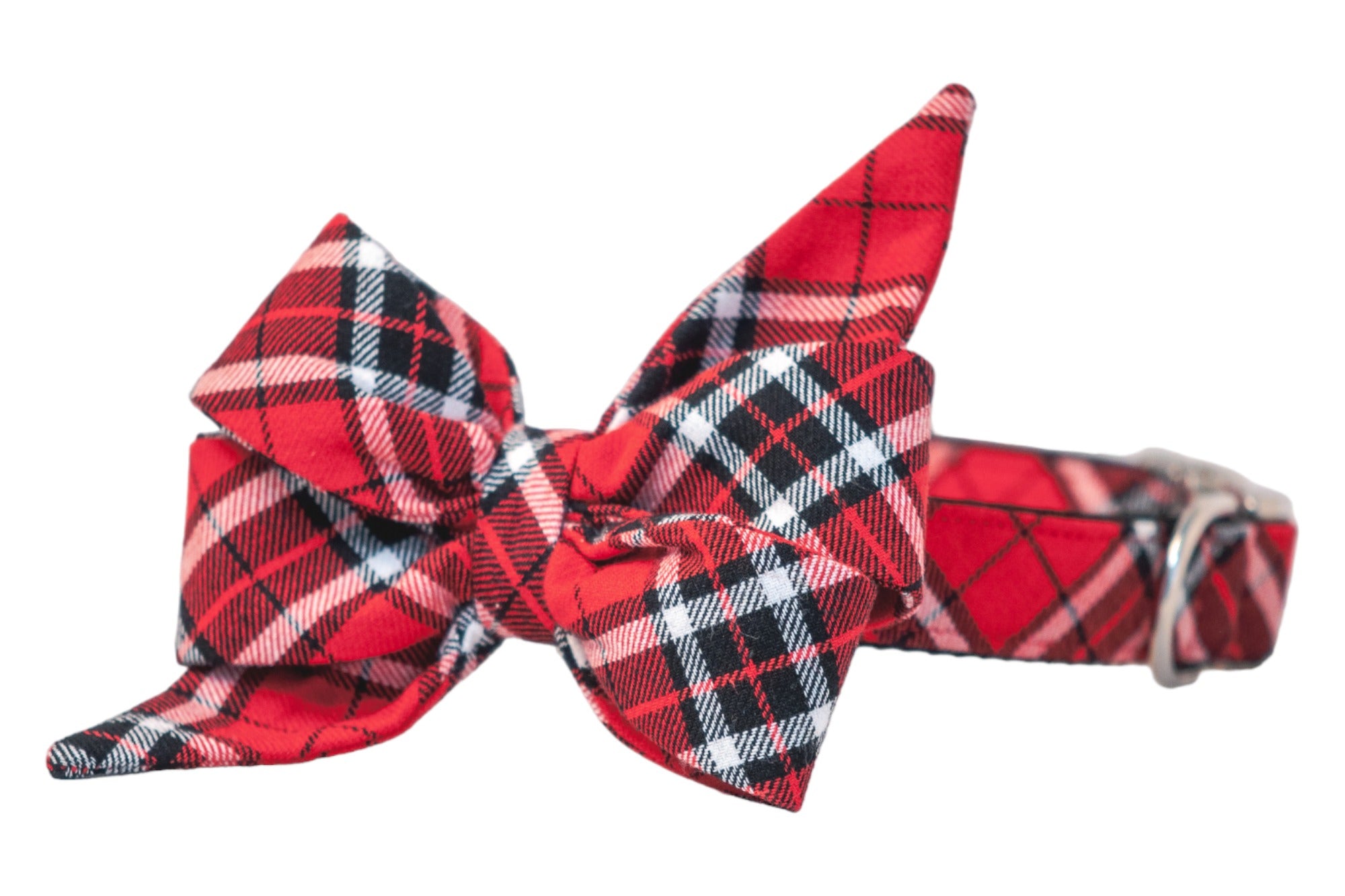 Dog collar with attached matching red tartan belle bow, featuring layered loops and long pointed tails in a festive red, black, and white plaid pattern—finished with silver hardware for a classic holiday look.