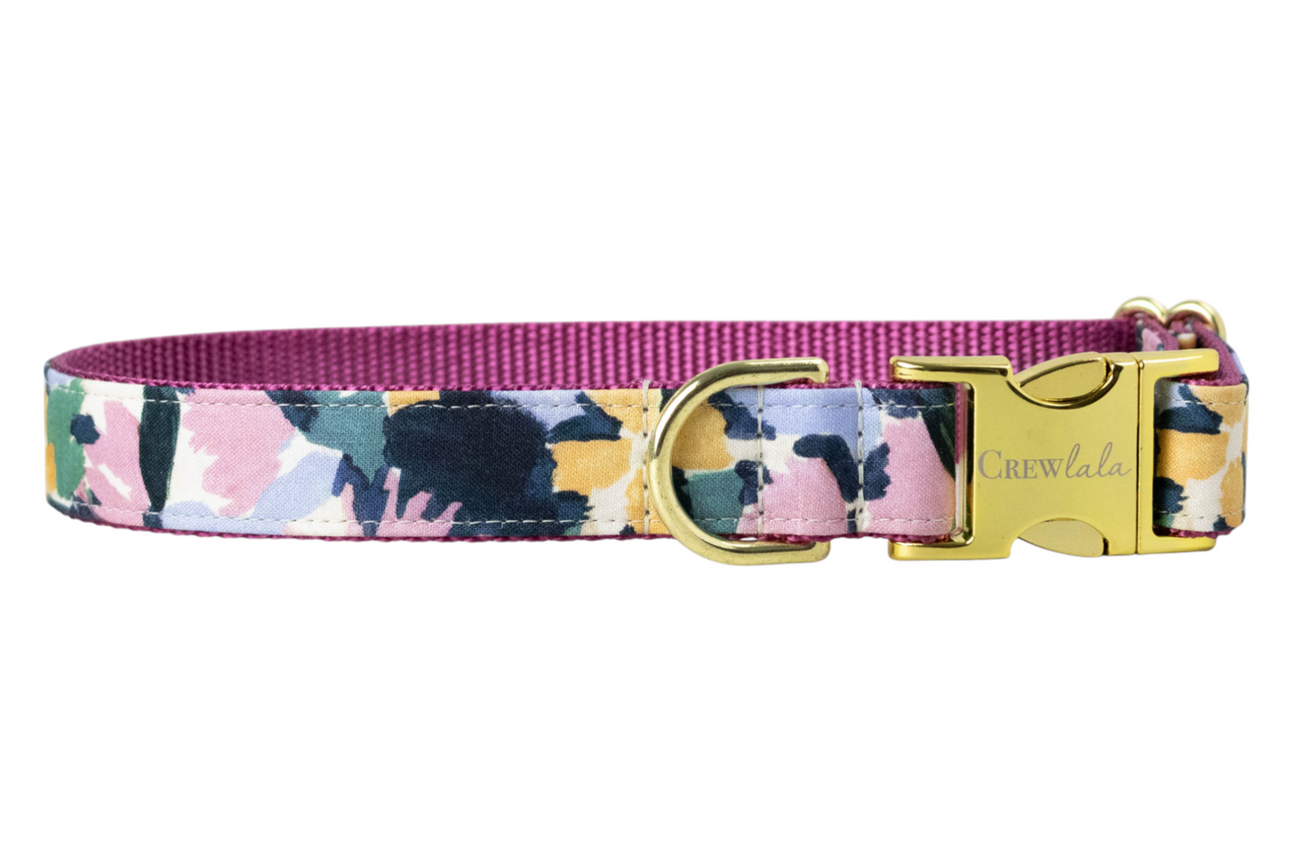 A floral dog collar featuring a pastel print thats perfect for fall. It includes a nylon woven backing, metal D-ring, and a buckle engraved with "Crewlala."
