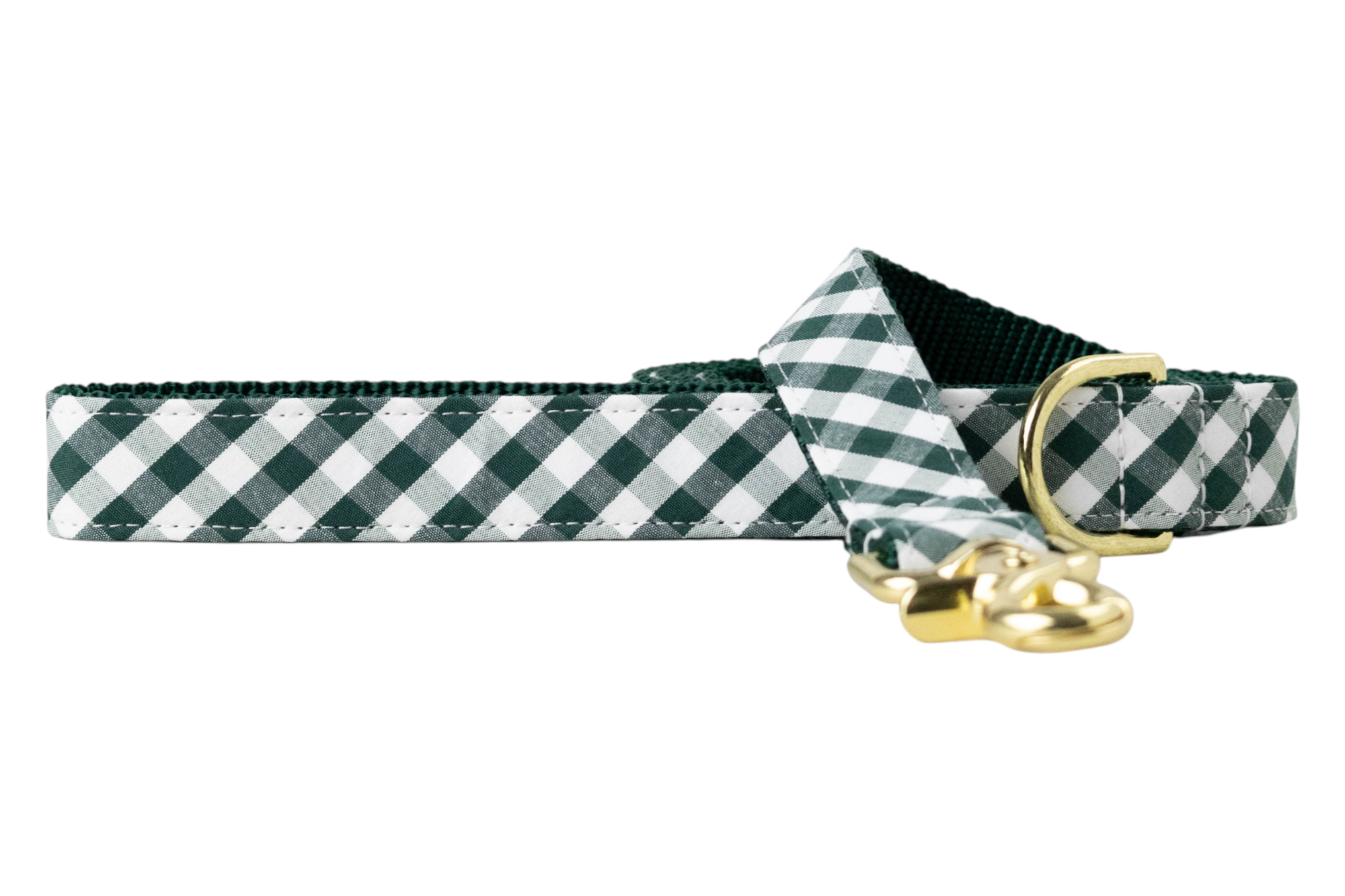Green dog leash with a classic plaid design, dark green nylon lining, and polished metal hardware.