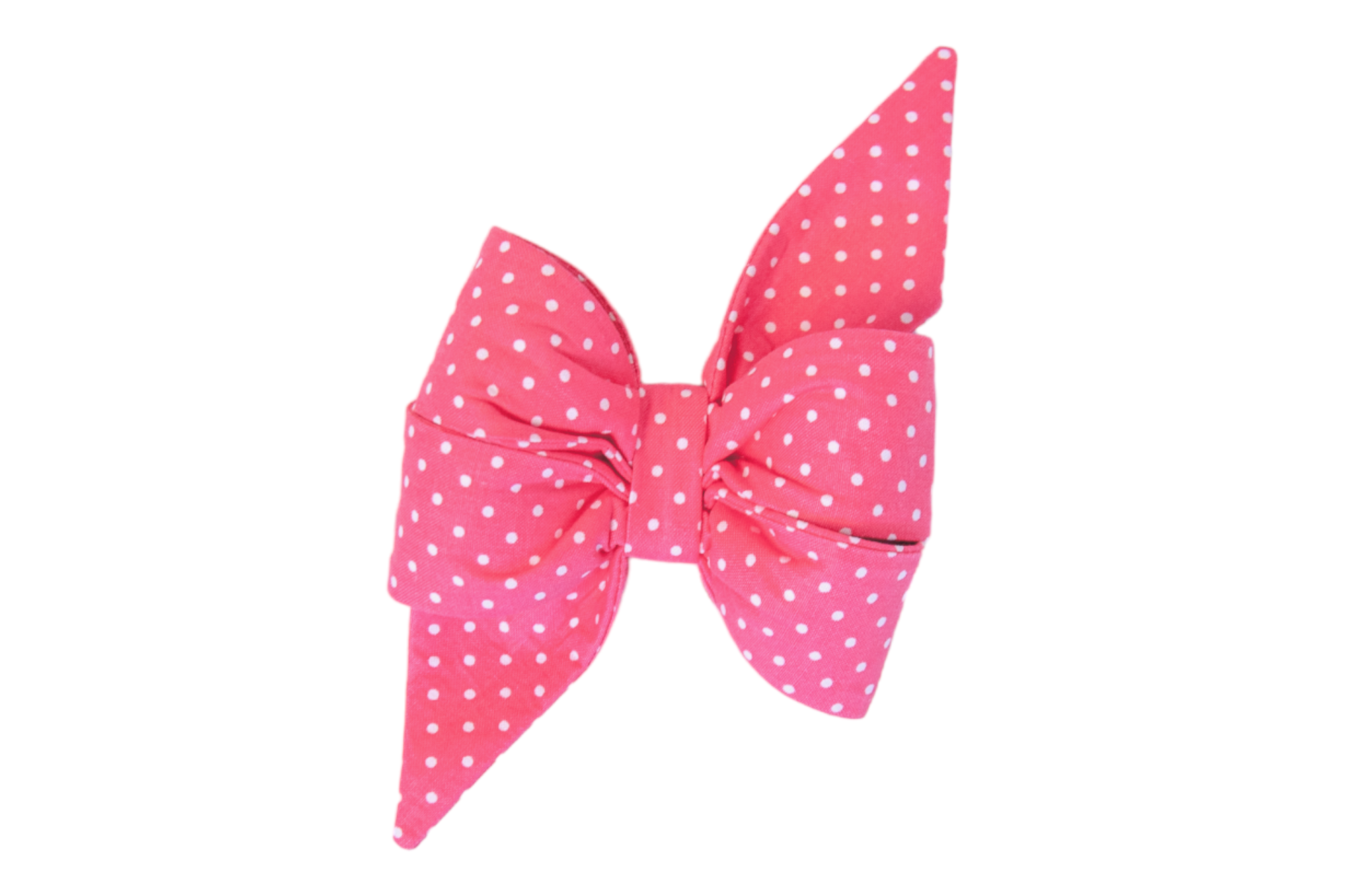 Bright pink double-loop dog belle bow with extended pointed ends, made from fabric printed with small white polka dots.