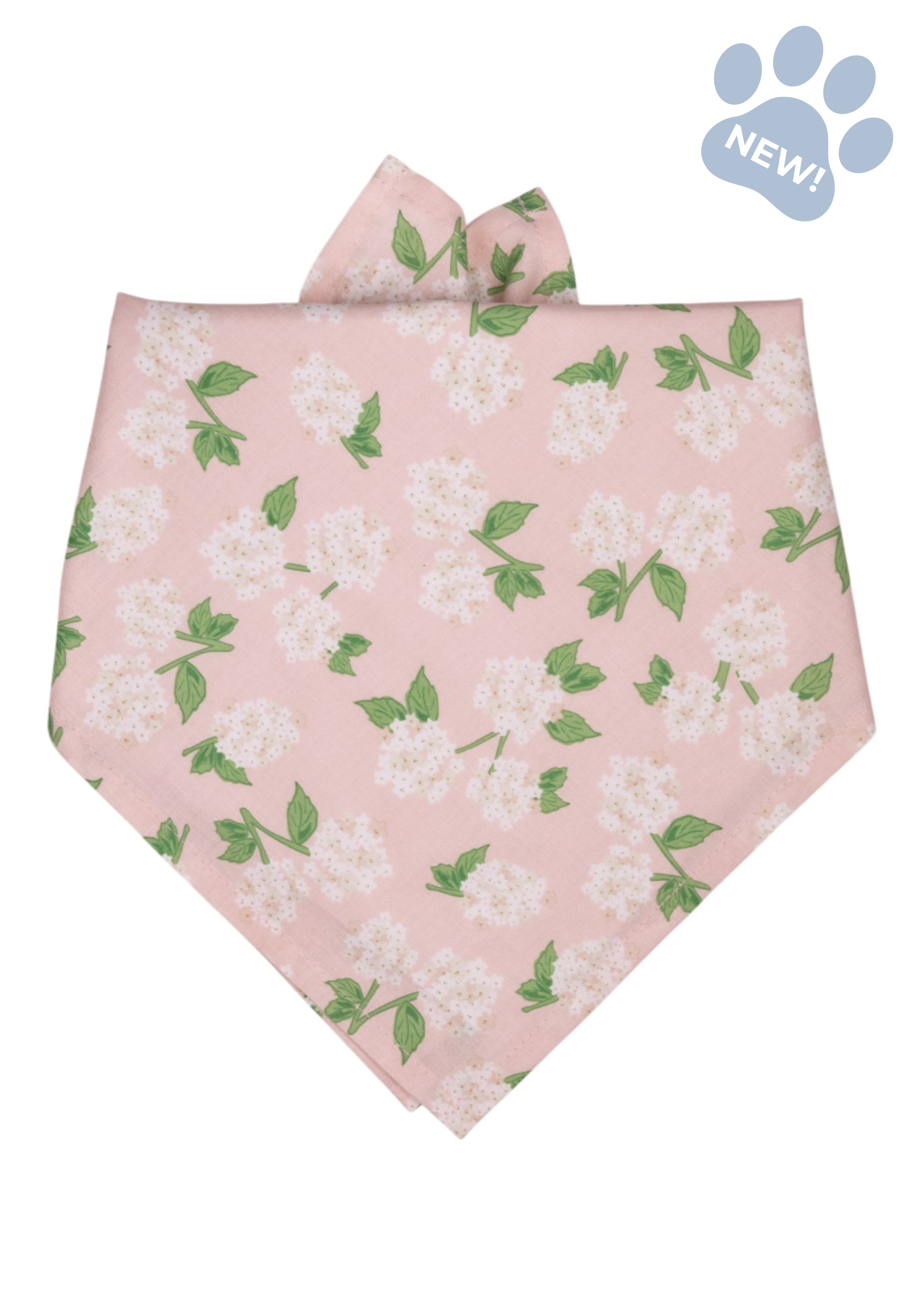 Hydrangea-print dog bandana featuring a blush pink background with white hydrangea blooms and green leaves, styled in a classic tie-on triangular shape.