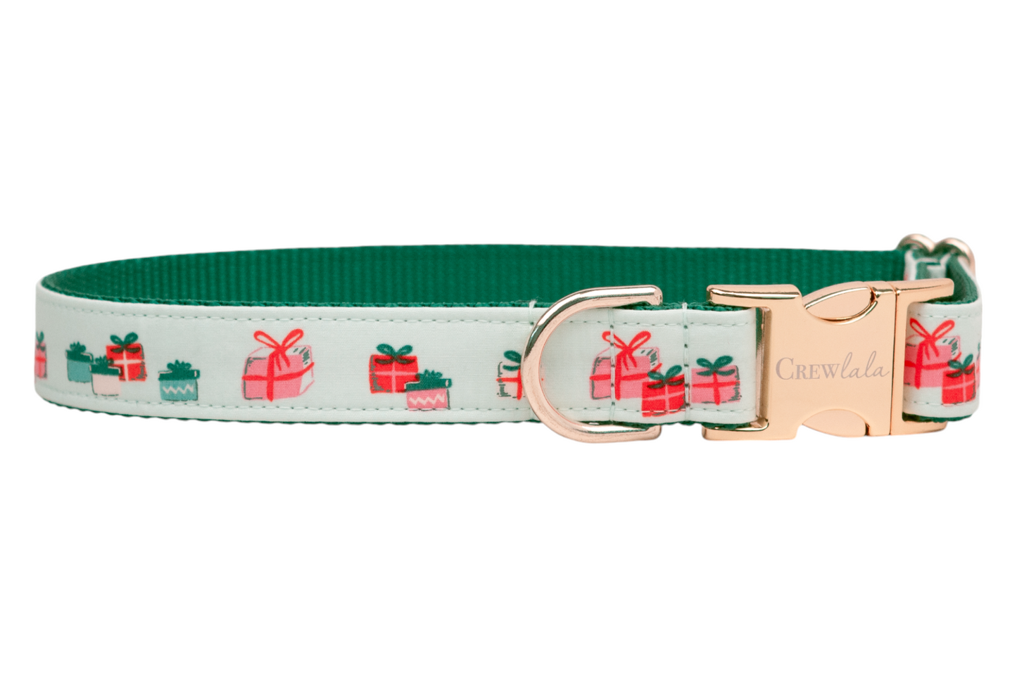 A festive dog collar with a soft green fabric with a repeating pattern of colorful gift boxes each tied with bows. The collar features a sturdy dark green nylon interior, a side-release buckle engraved with the brand name "Crewlala," and a matching D-ring.