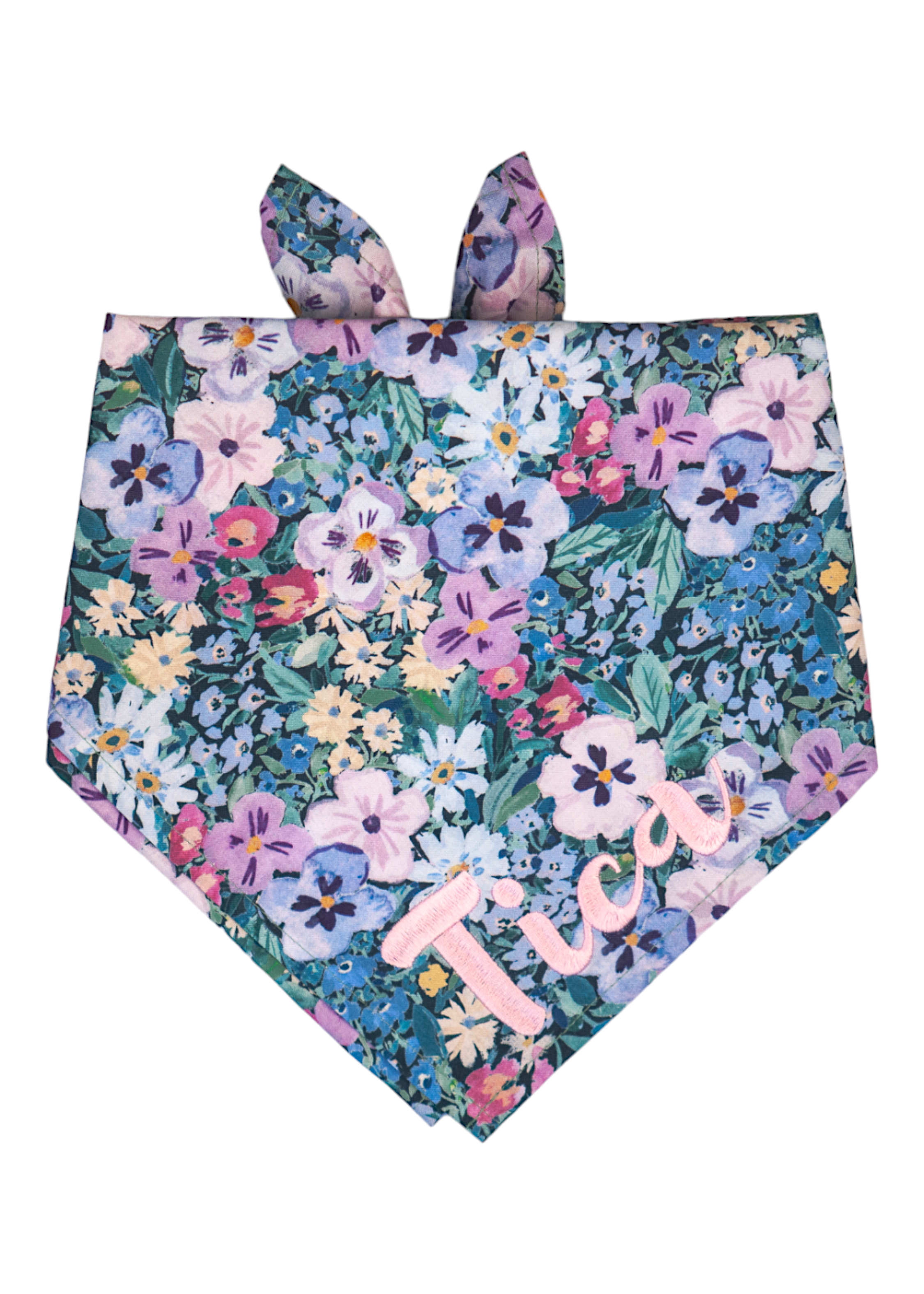 Colorful bandana for dogs adorned with a vibrant mix of hand-painted style pansy flowers, primarily in cool tones, and personalized with the name “Tica” in embroidered script.