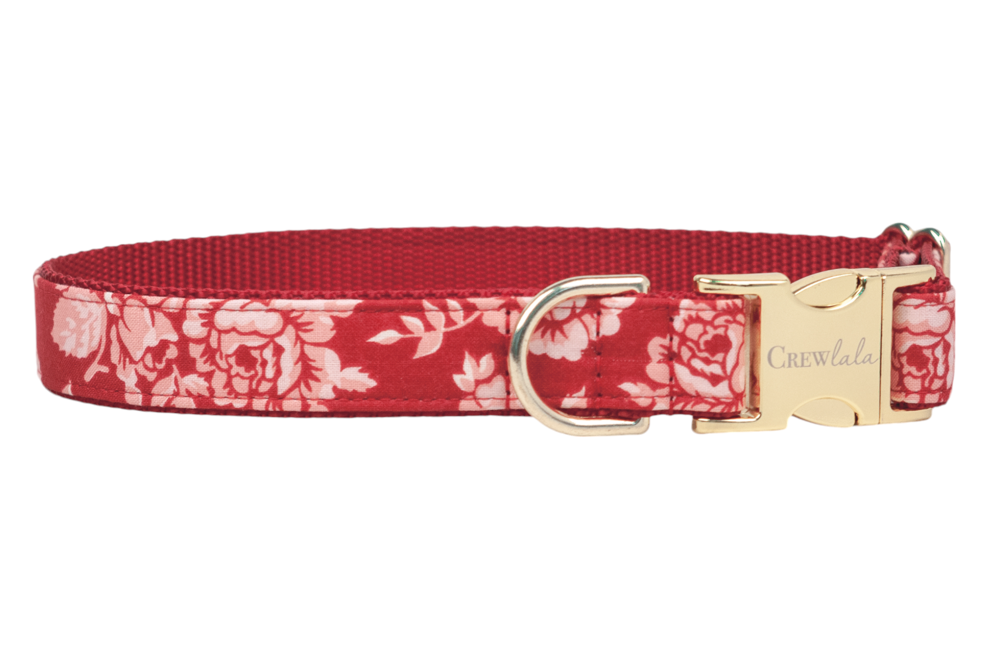 A red floral dog collar featuring a soft rose pattern and metal hardware. The collar includes an engraved buckle reading “Crewlala,” a D-ring for leash attachment, and a strong red woven backing. Handmade in Charleston, SC.