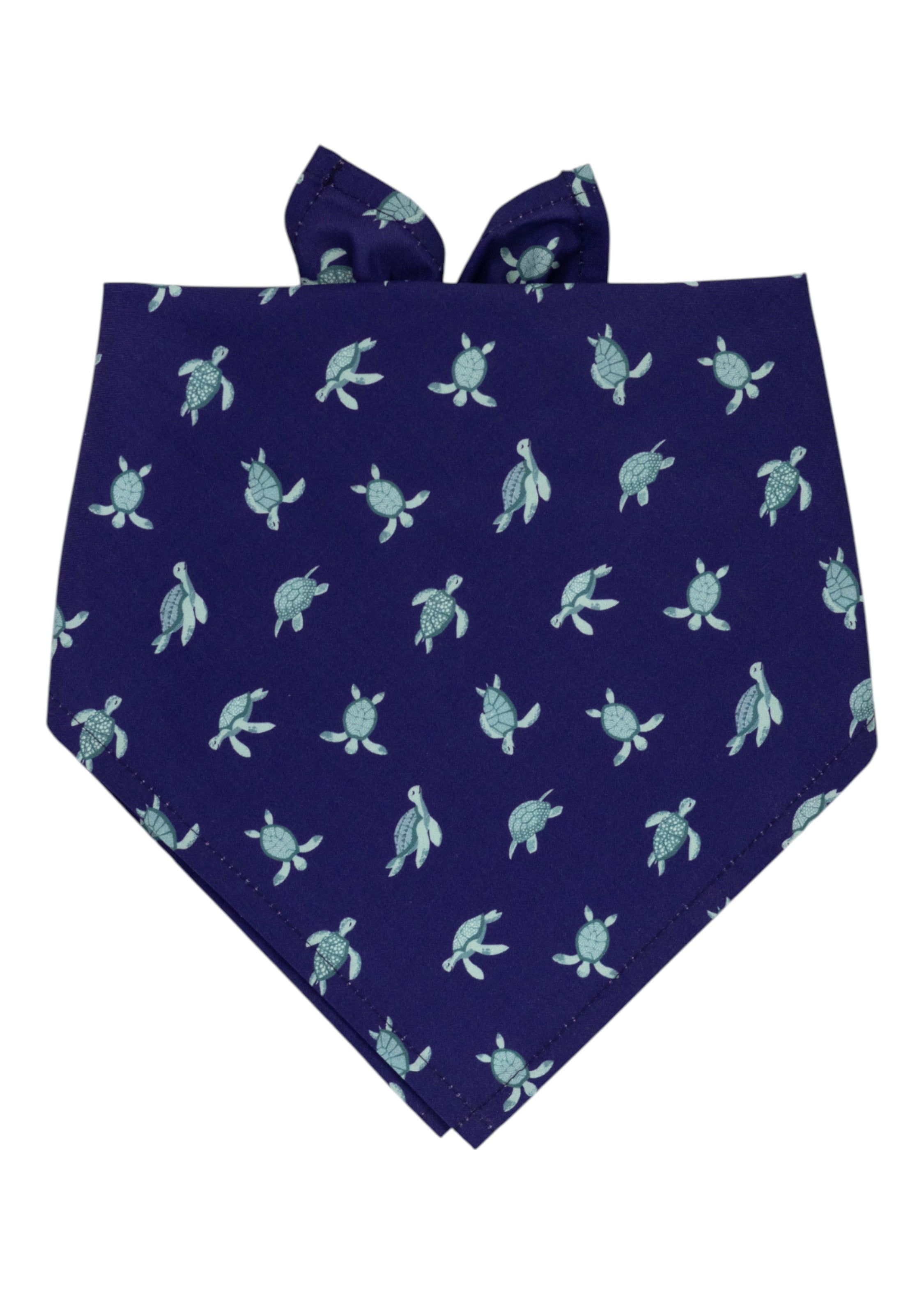 A deep navy dog bandana with a repeating pattern of light turquoise sea turtles. The bandana is folded into a triangular shape with tie-up ends visible at the top.