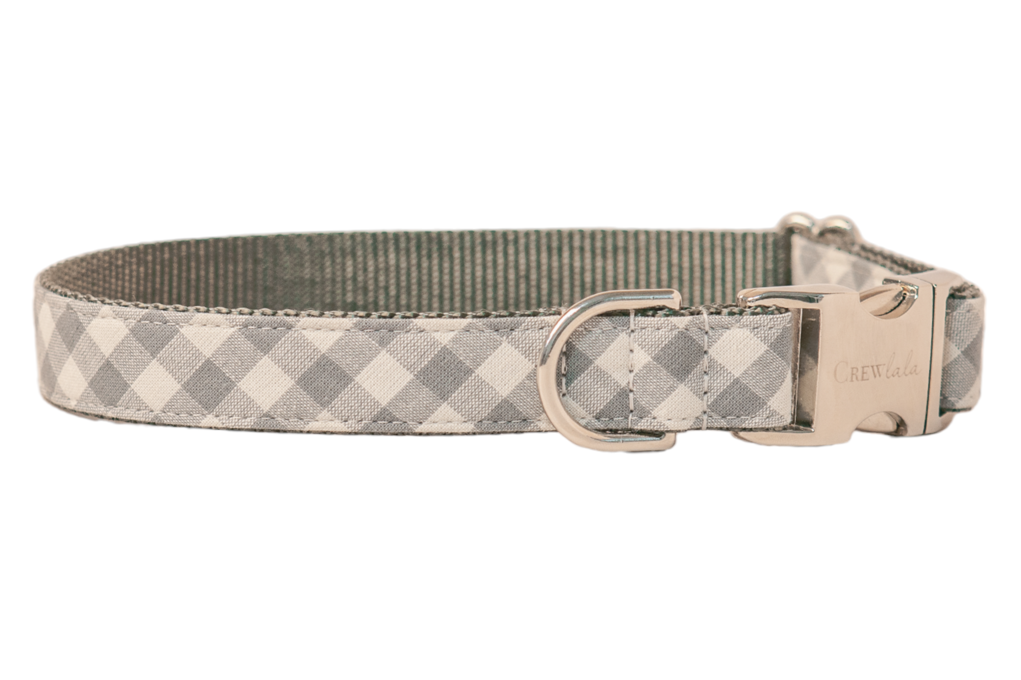 Stylish dog collar in pale gray gingham design, mounted on strong gray woven webbing for durability. The hardware includes a shiny clasp engraved with “Crewlala,” a robust D-ring for leash connection, and a metal sizing slider. Clean, even stitching outlines the collar, highlighting its neat, tailored construction.