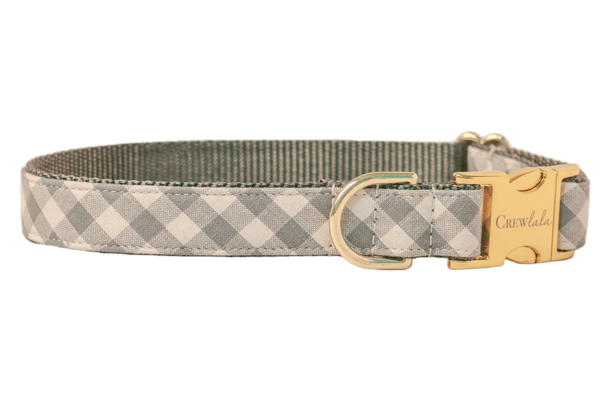 Stylish dog collar in pale gray gingham design, mounted on strong gray woven webbing for durability. The hardware includes a shiny clasp engraved with “Crewlala,” a robust D-ring for leash connection, and a metal sizing slider. Clean, even stitching outlines the collar, highlighting its neat, tailored construction.