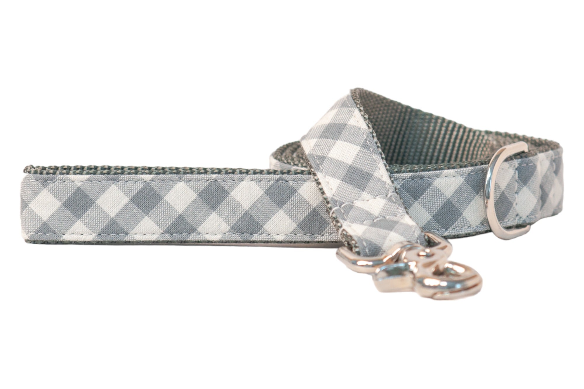 Dog leash made from durable webbing covered in a light gray gingham plaid fabric, featuring reinforced stitching along the edges, a shiny metal swivel clasp for attachment, and a matching D-ring near the handle.
