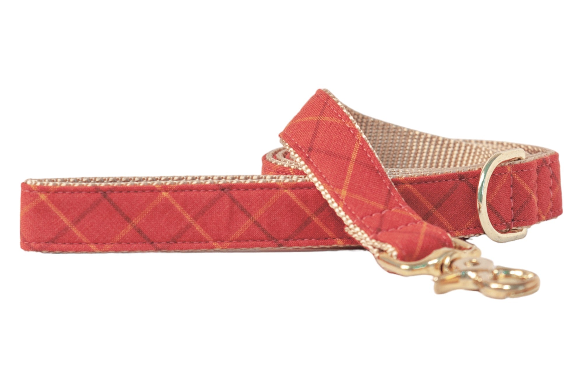 Flannel dog leash in warm orange with faint diagonal lines forming a diamond grid. Nylon woven lining adds contrast, and polished hardware provides a refined finish.