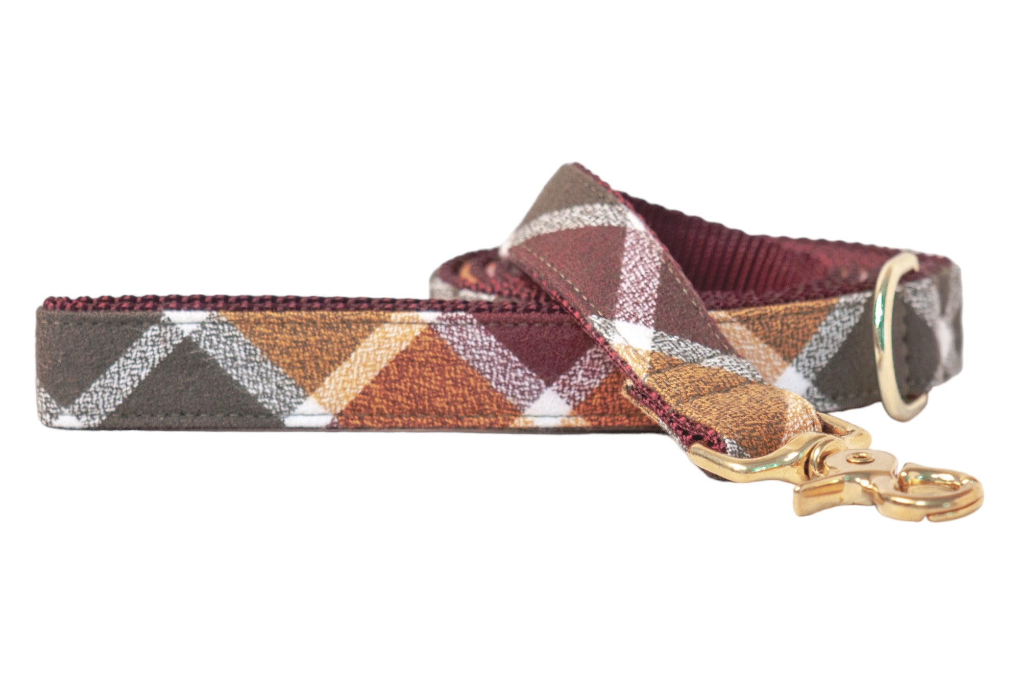 Dog leash in rich autumn plaid, made from flannel fabric with reinforced stitching, a swivel clasp, and a matching D-ring near the handle loop.
