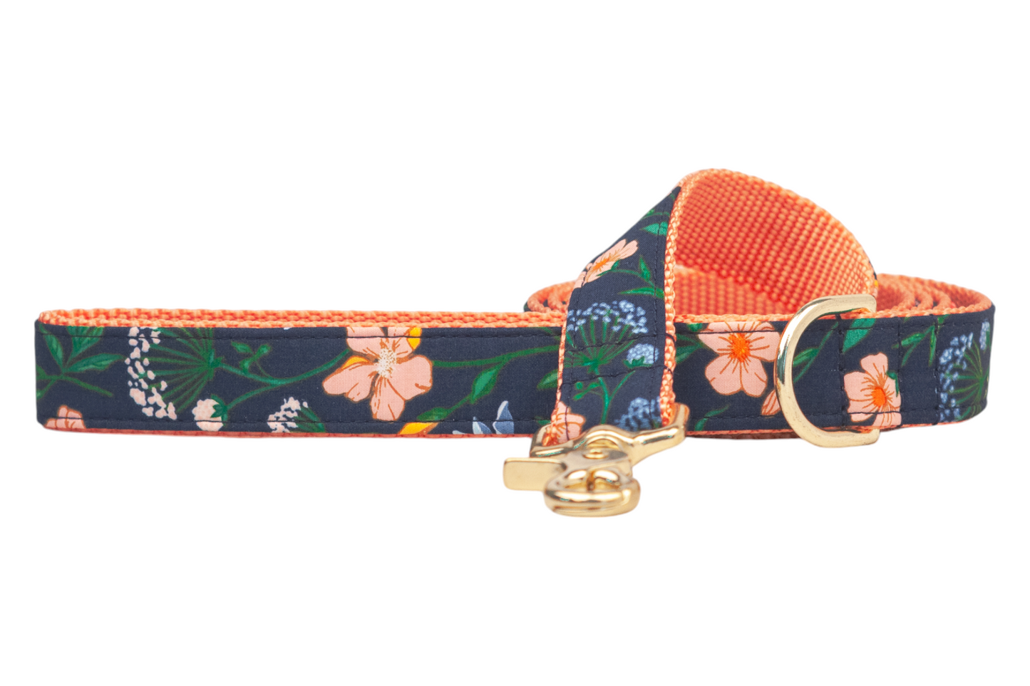 Navy floral dog leash featuring scattered blossoms in and foliage. The leash has an nylon woven interior and is completed with metal hardware, including a leash clip and ring attachment.