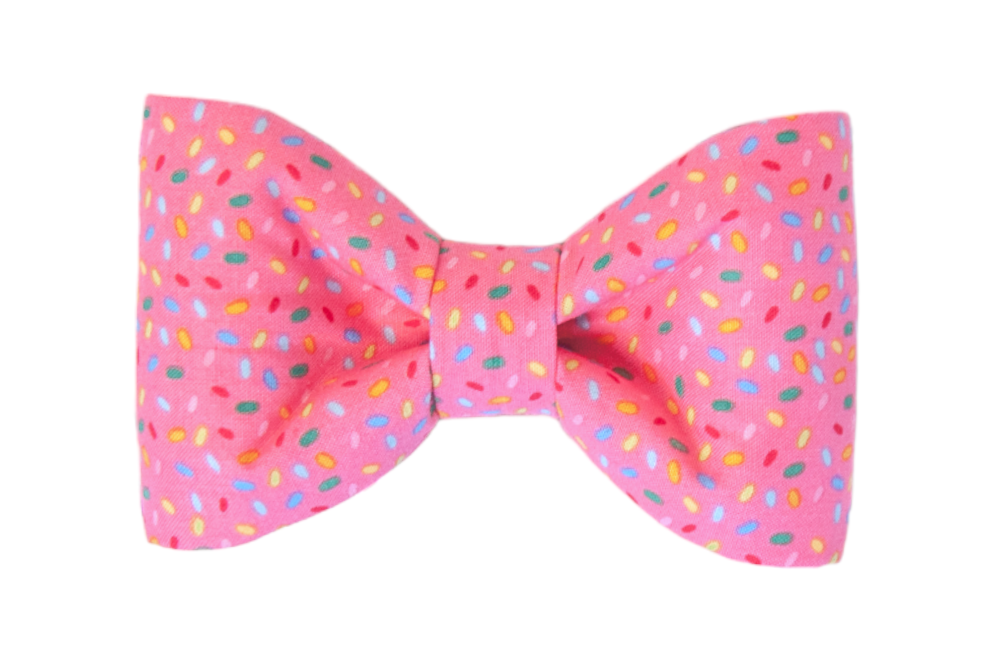Playful dog bow tie made from bright pink fabric covered in multicolored sprinkle shapes. The bow has a classic shape with softly curved sides.