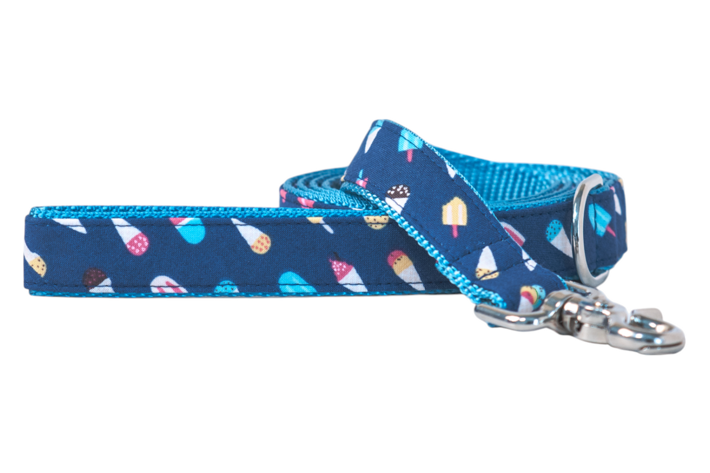 Stylish dog leash with a whimsical ice cream print on a blue fabric exterior and bright blue woven backing. The leash includes a brass-colored swivel clasp and metal D-ring, suggesting high-quality construction and fun summer vibes.