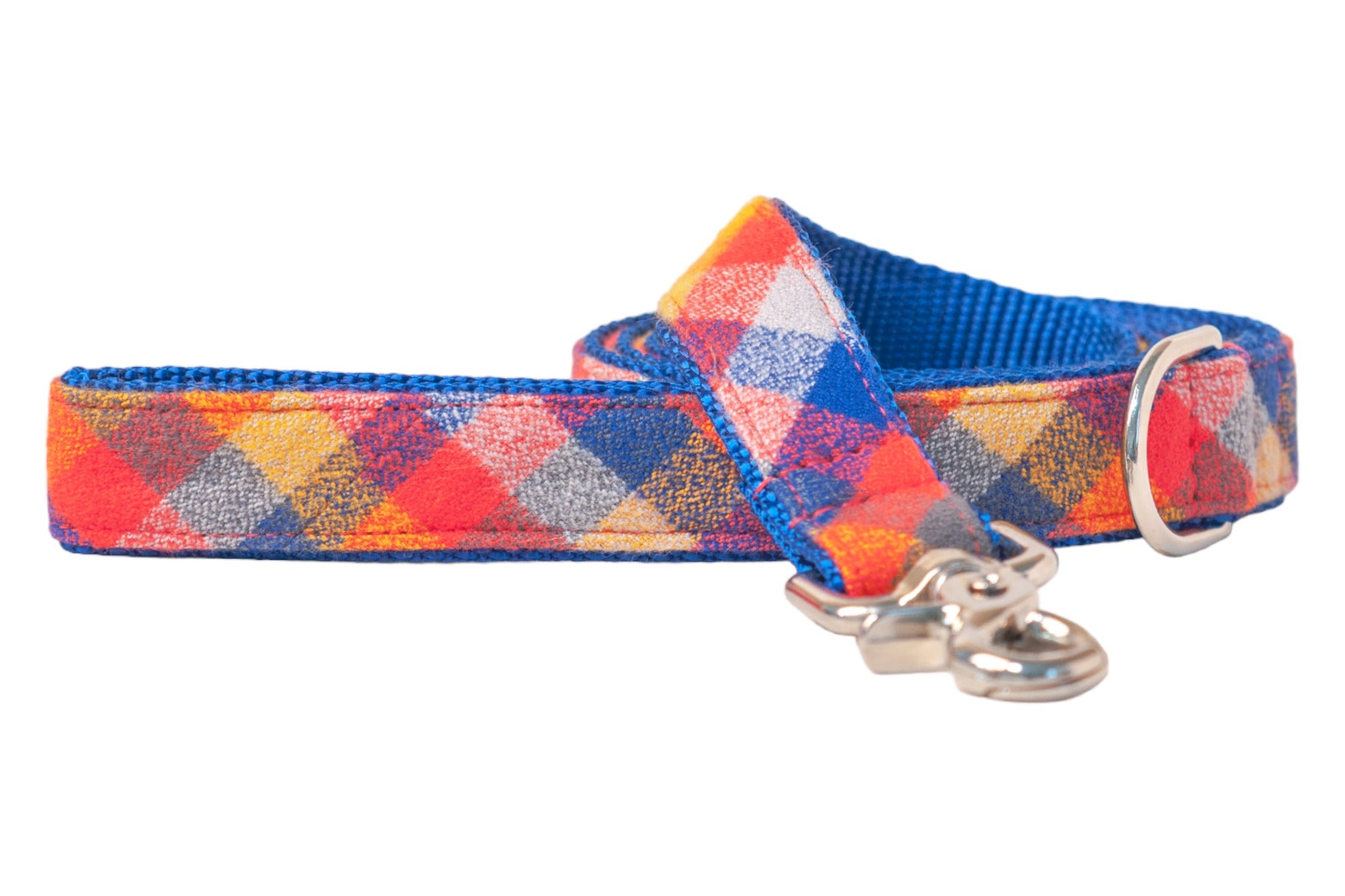 Colorful plaid leash featuring intersecting blocks of red, orange, blue, with a vibrant blue nylon webbing base, and equipped with a polished clasp.