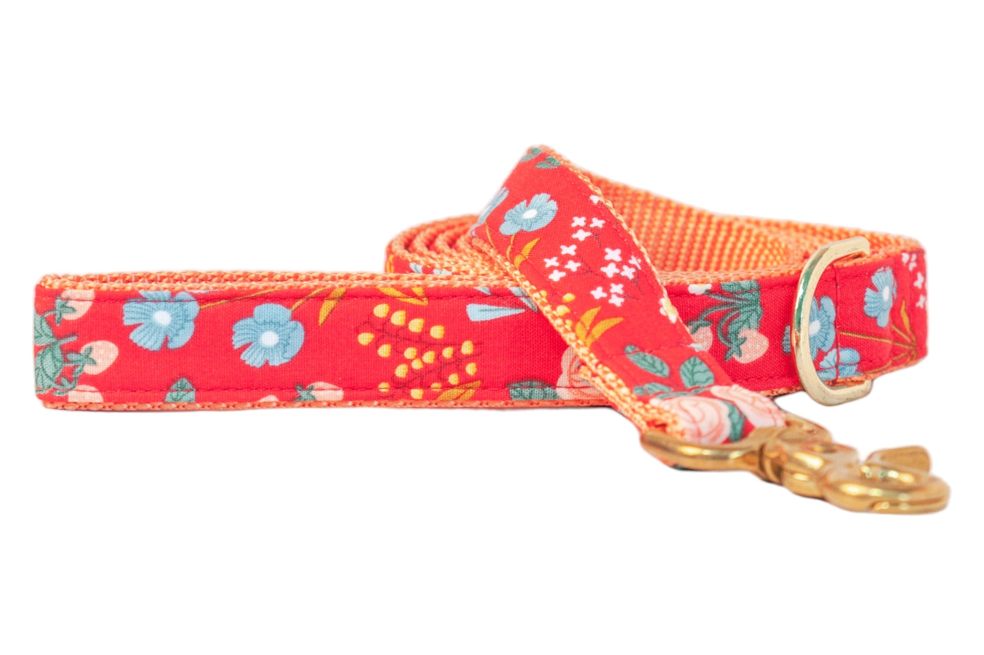 Bright and blooming, this floral dog leash features a fiery red background with scattered wildflowers in colors, complemented by nylon lining and polished clip.
