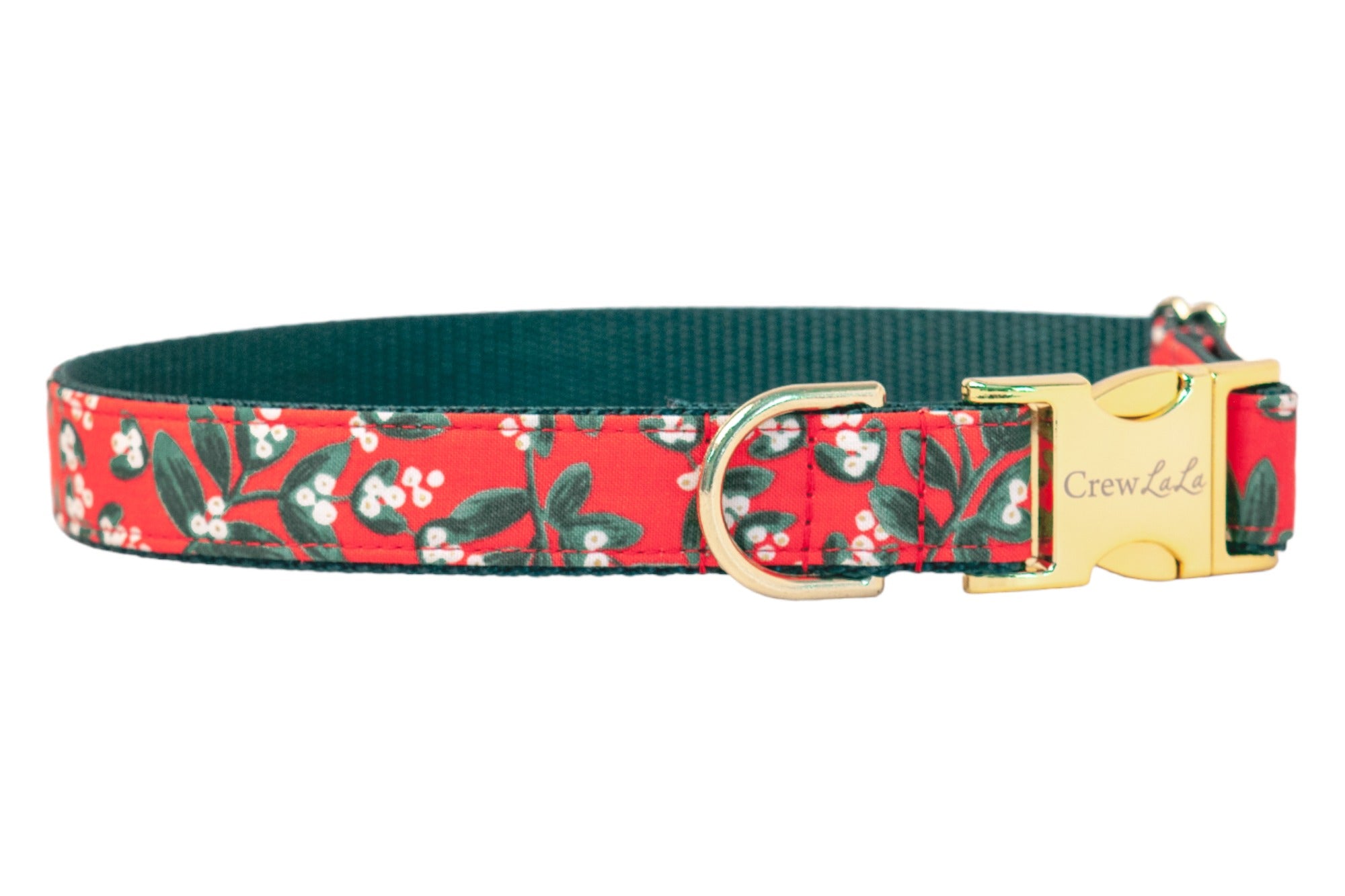 Red dog collar with a festive mistletoe print, featuring leaves and berries on a soft fabric exterior, dark woven interior, and polished buckle and D-ring—made for pups who love to sparkle through the season.
