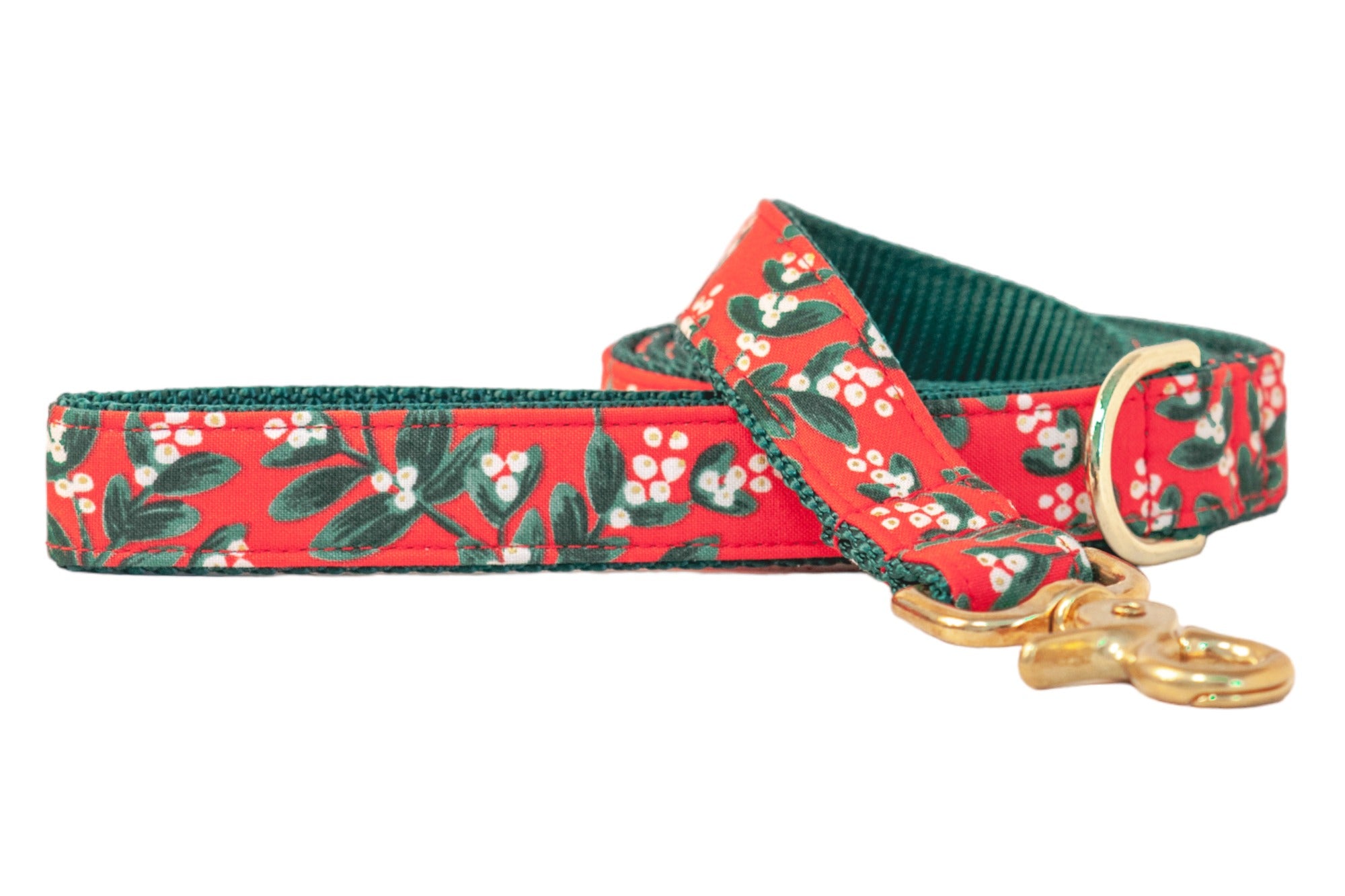 Holiday-themed dog leash with a bright red background and all-over mistletoe print, finished with lining and polished hardware for a touch of seasonal sparkle on every walk.