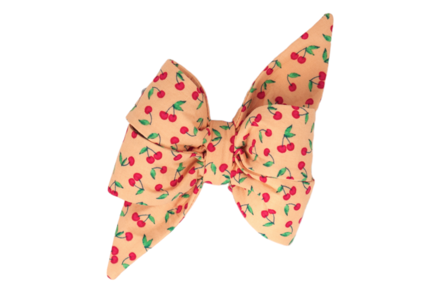 Add a touch of summer charm with this cherry-printed girl dog belle bow on a warm peach background.