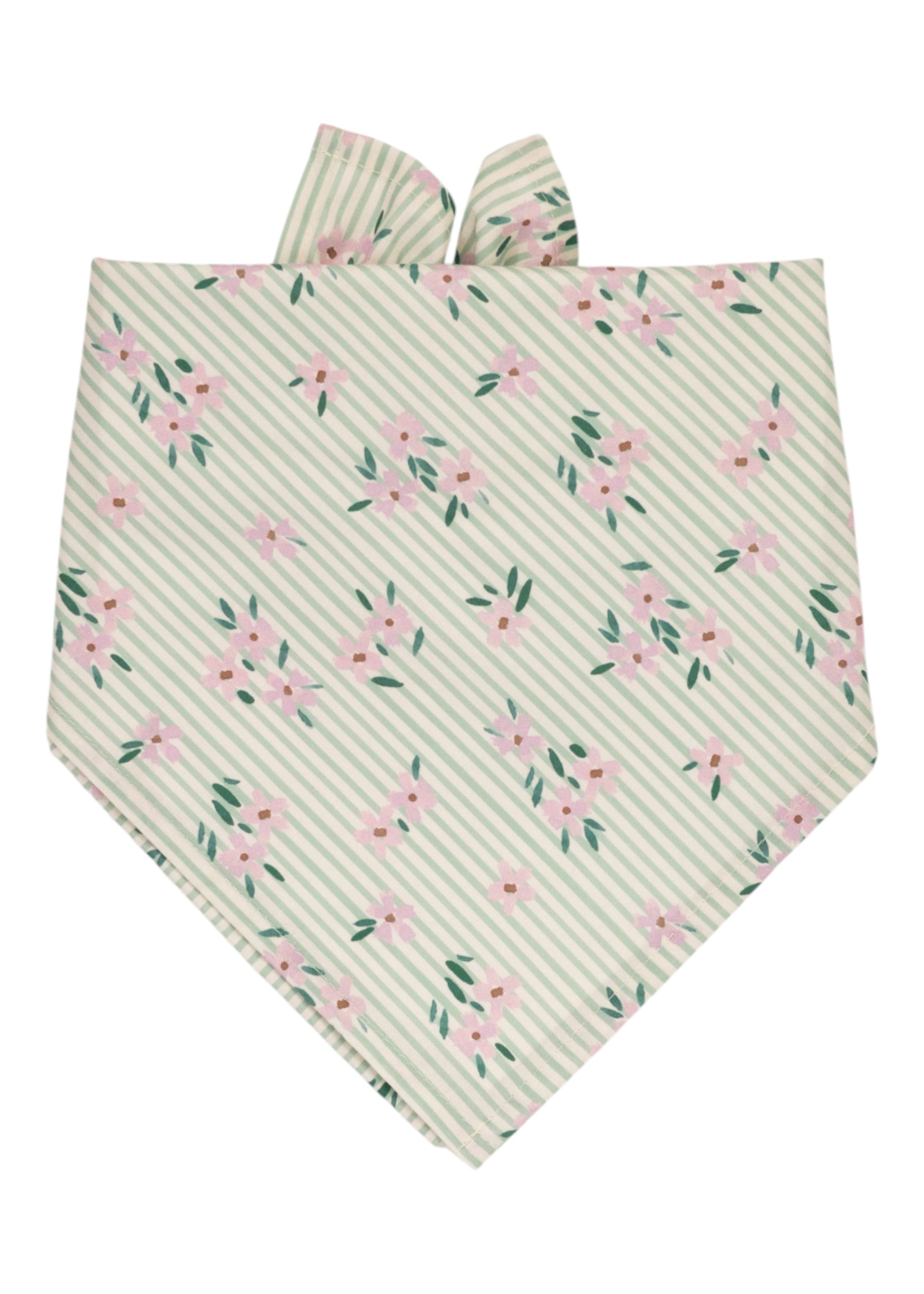 Striped green and white dog bandana decorated with scattered pink flowers and leafy green accents, folded into a triangle with two soft fabric tips at the top.