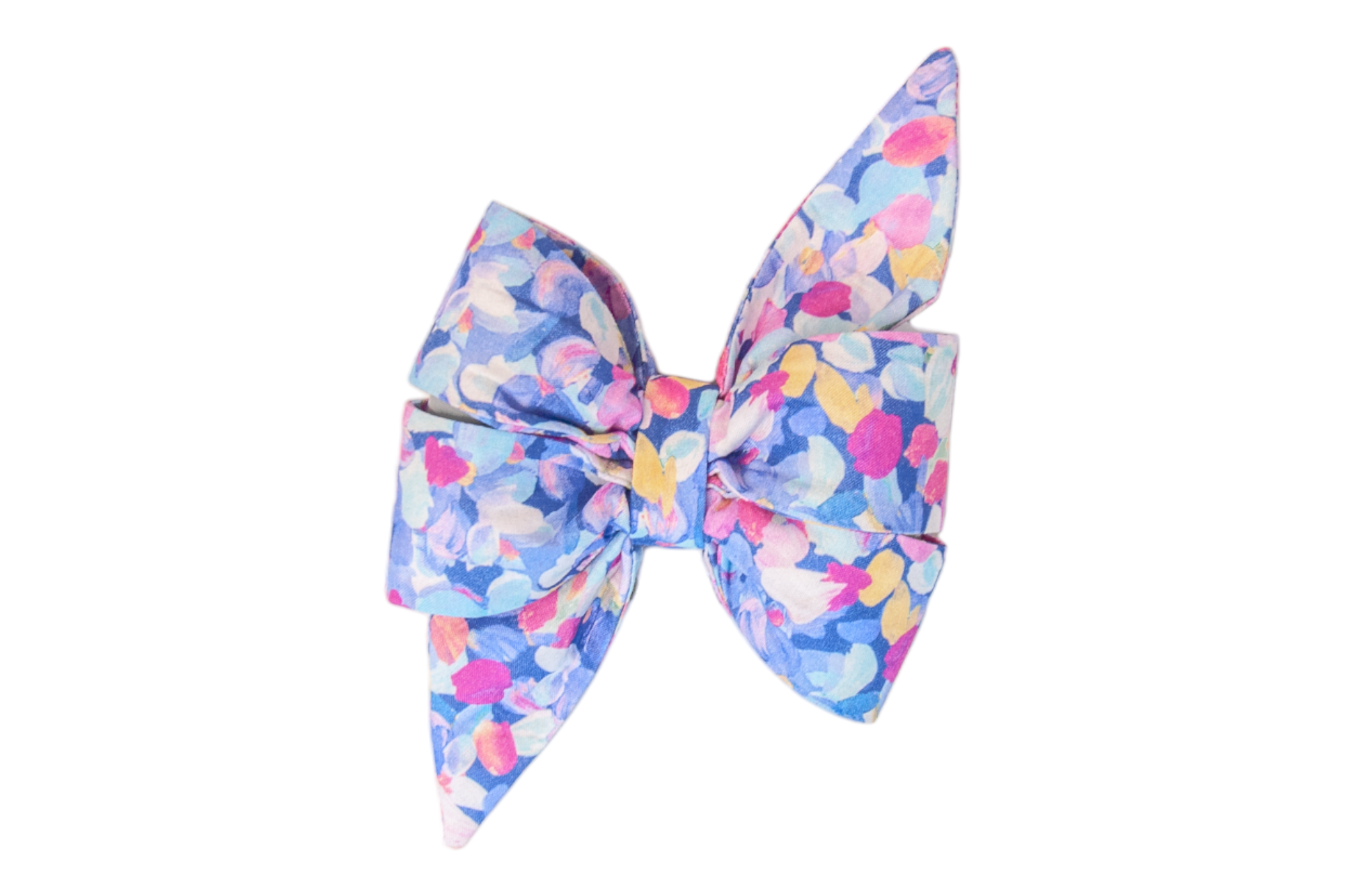 A bold, feminine, and colorful belle bow made from fabric with a painterly floral pattern. The design includes soft, overlapping petal shapes in a palette of sky blue, fuchsia, violet, yellow, and white. The bow features wide, structured loops and long, pointed ends, giving it a dramatic and stylish appearance.