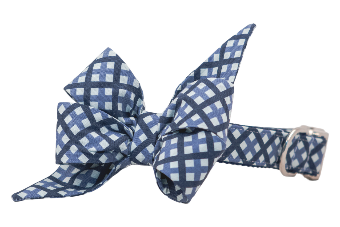 Statement dog collar with a structured, feminine belle bow made of fabric in a classic plaid design of navy and light blue. The belle bow is affixed to a matching collar with a metal D-ring for leash or ID tag attachment.