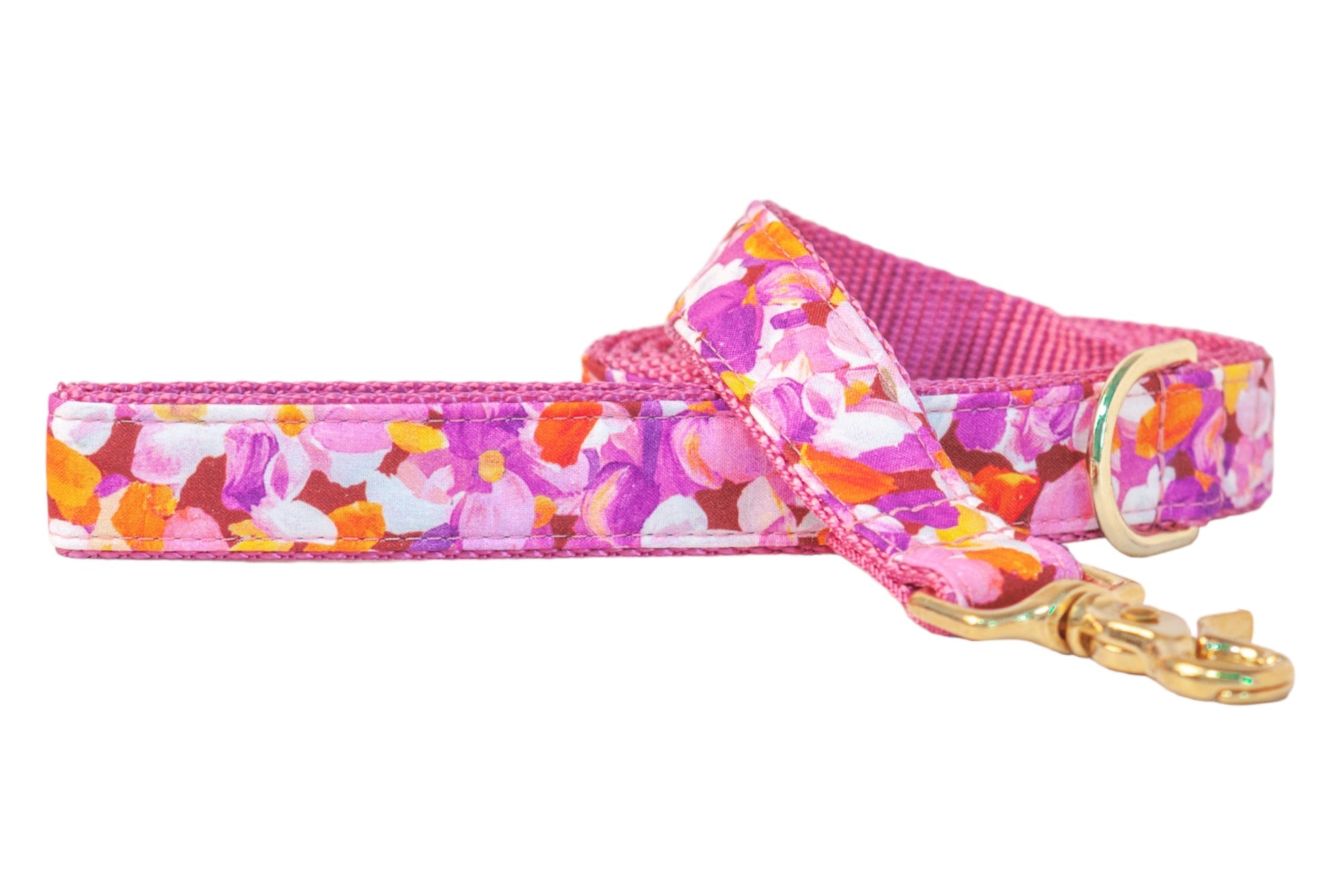 A vibrant floral dog leash bursting with pinks and purple petals, finished with luxe hardware — perfect for pups who love to strut in color.