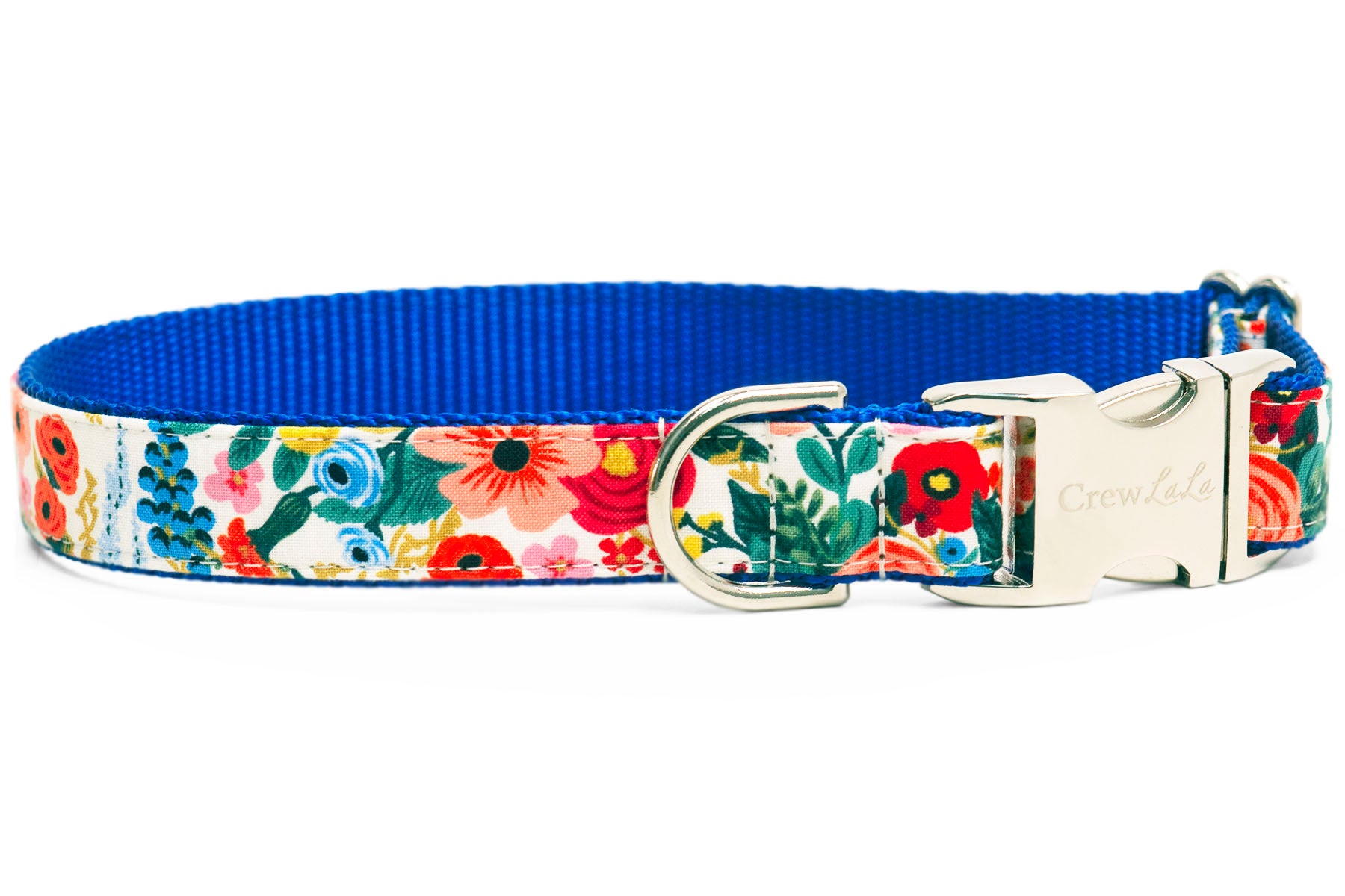 A colorful floral dog collar with a silver metal buckle engraved with "Crew LaLa." The collar features a vibrant pattern of multicolored flowers on a pale background and a royal blue inner webbing.