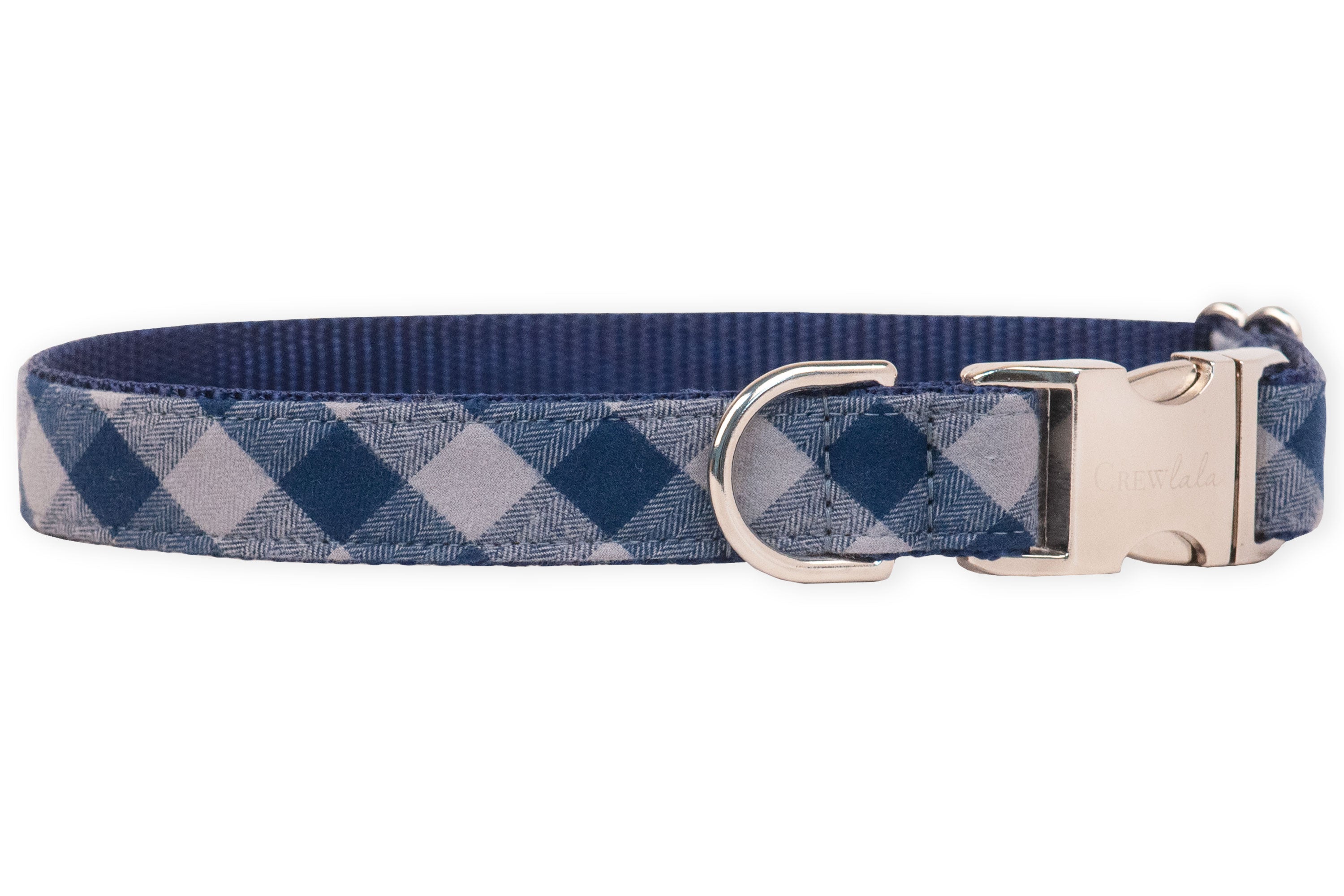 A stylish navy plaid dog collar with metal hardware and an engraved buckle, blending everyday durability with upscale charm for the pup who likes to strut in style.