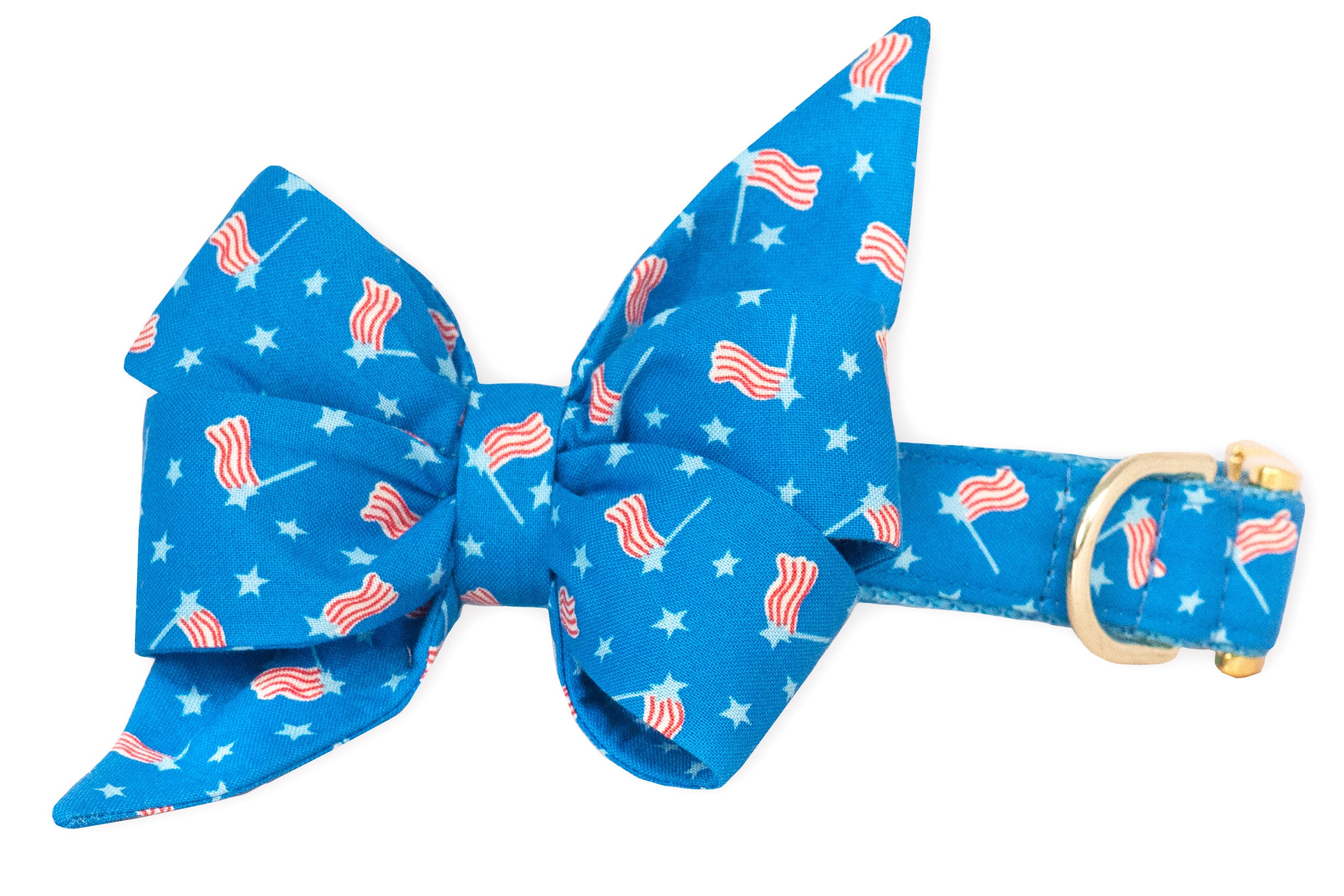 Patriotic dog collar in sky blue, complete with an oversized, feminine, matching fabric belle bow featuring a red, white, and blue flag-and-star print. The gold-tone D-ring and buckle add a polished, celebratory touch.