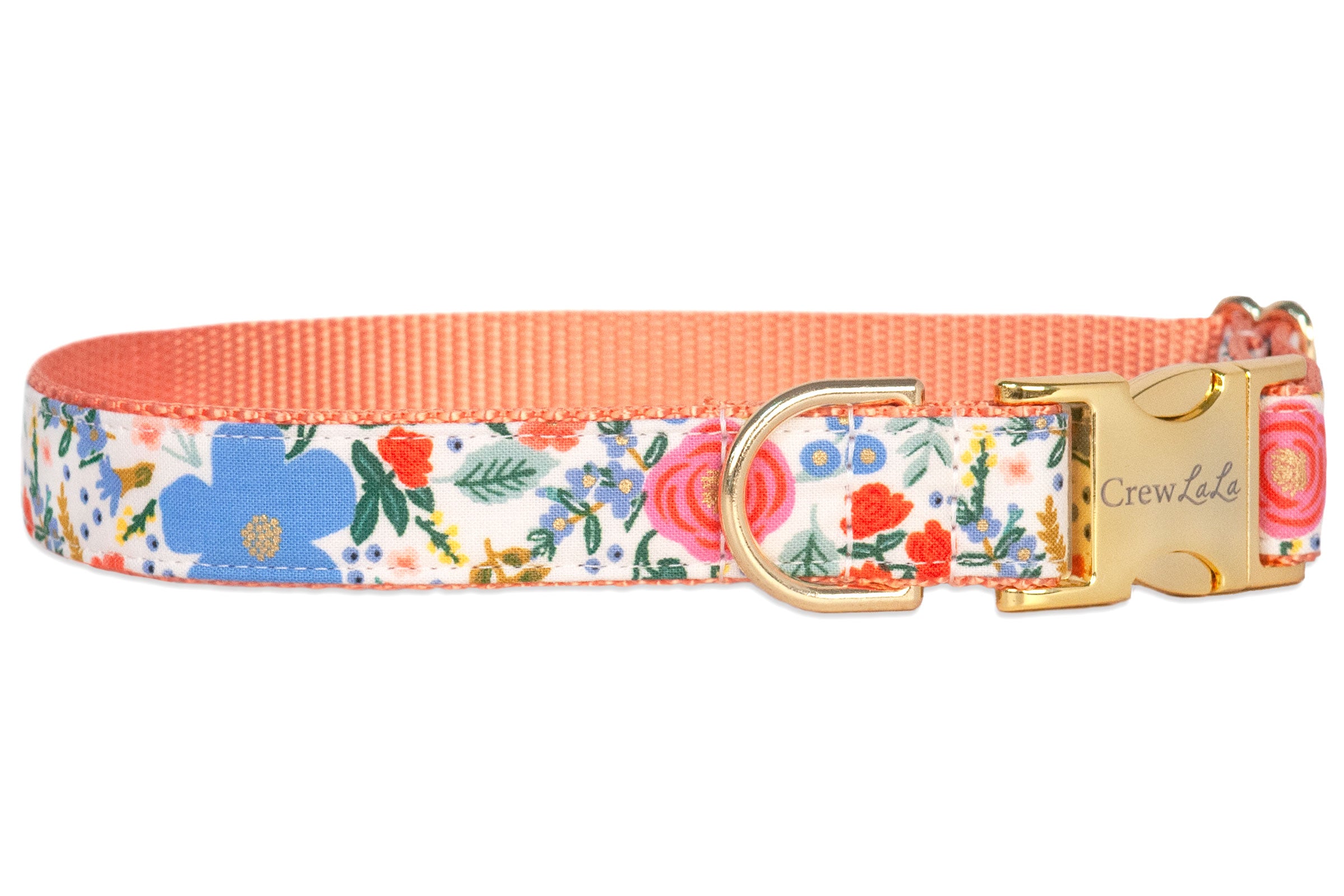 A fabric dog collar with a floral pattern featuring blue, pink, orange, and green elements on a white background. The collar has a peachy orange inner webbing, a gold metal D-ring, and a gold side-release buckle.