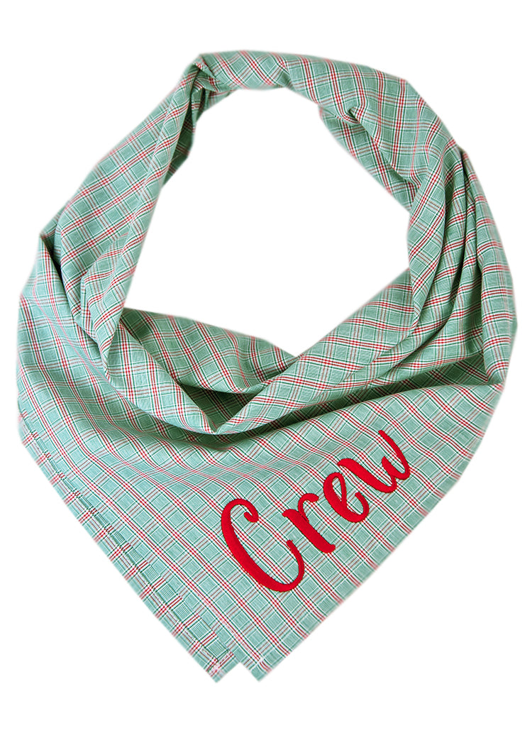 A crisp, cool plaid dog bandana in green—perfect for holiday photos, spring strolls, or just turning heads year-round. It has the name "Crew" embroidered on the bottom right.