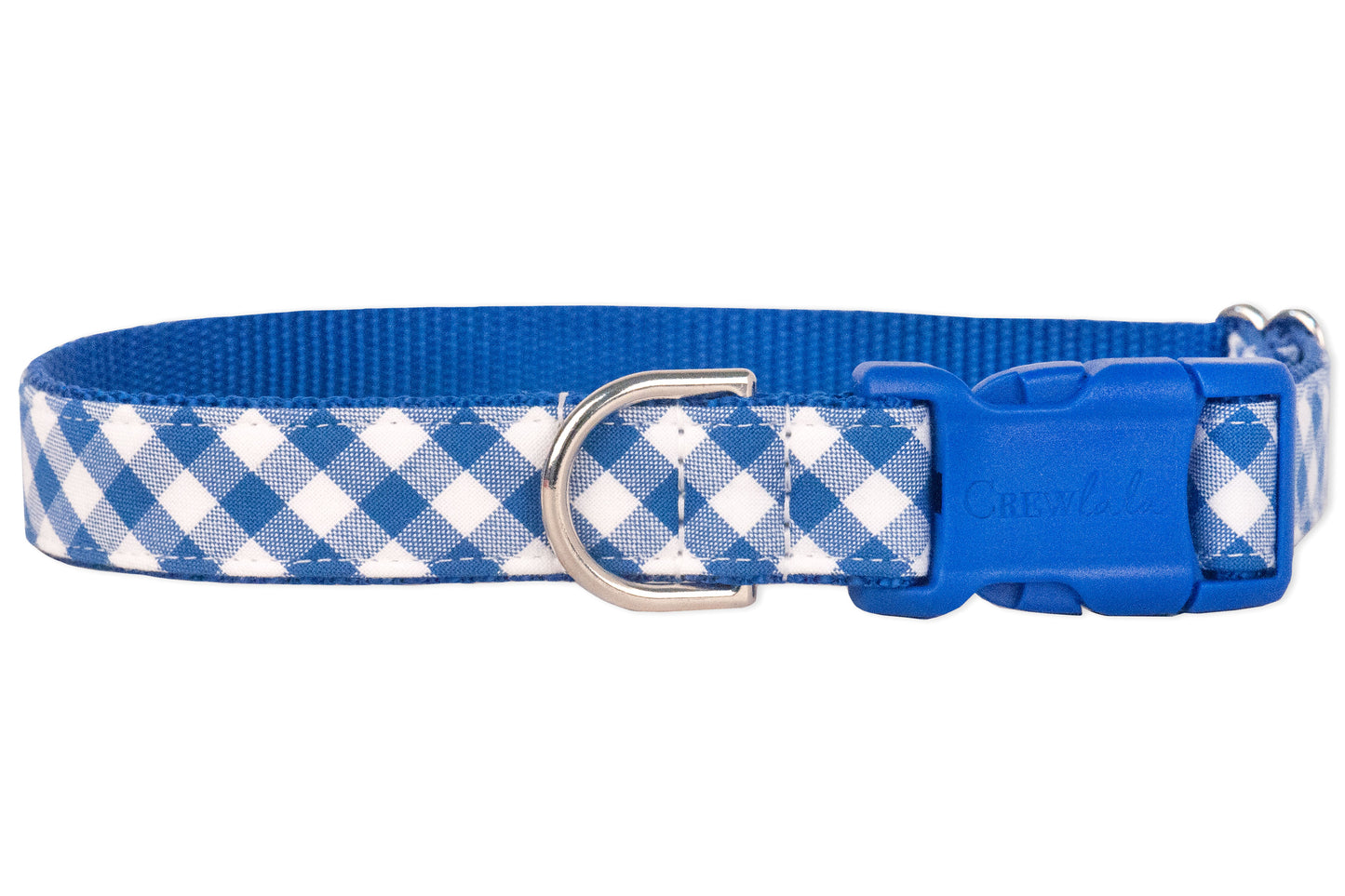 A dog collar with a classic blue and white plaid checkered pattern on the outer fabric and a solid blue woven nylon backing. The collar features a side-release blue plastic buckle and a silver metal D-ring for leash attachment, combining style with durability.