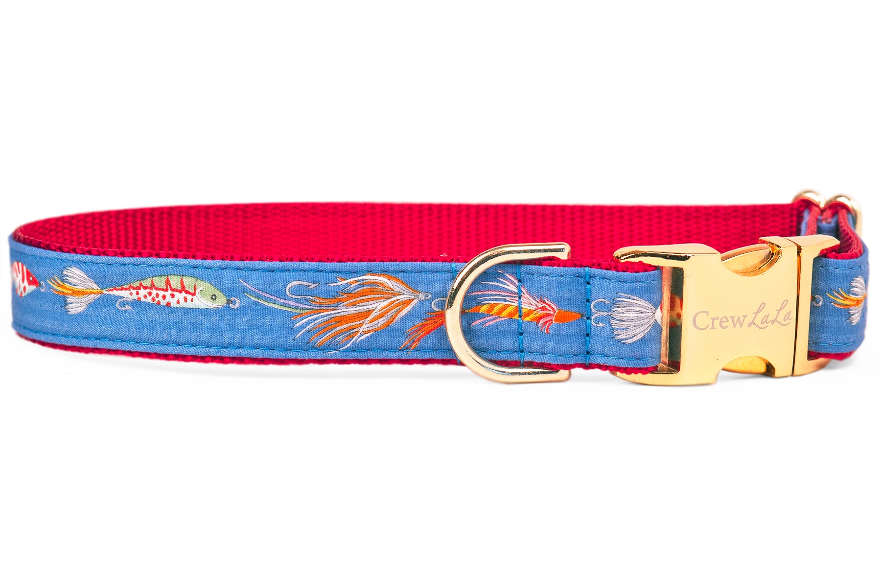 A close-up of a blue dog collar with a red interior featuring a playful fishing lure print, including hooks, feathers, and striped bait. The collar is finished with a shiny gold side-release buckle engraved with "CrewLala" and a sturdy D-ring for leash attachment.