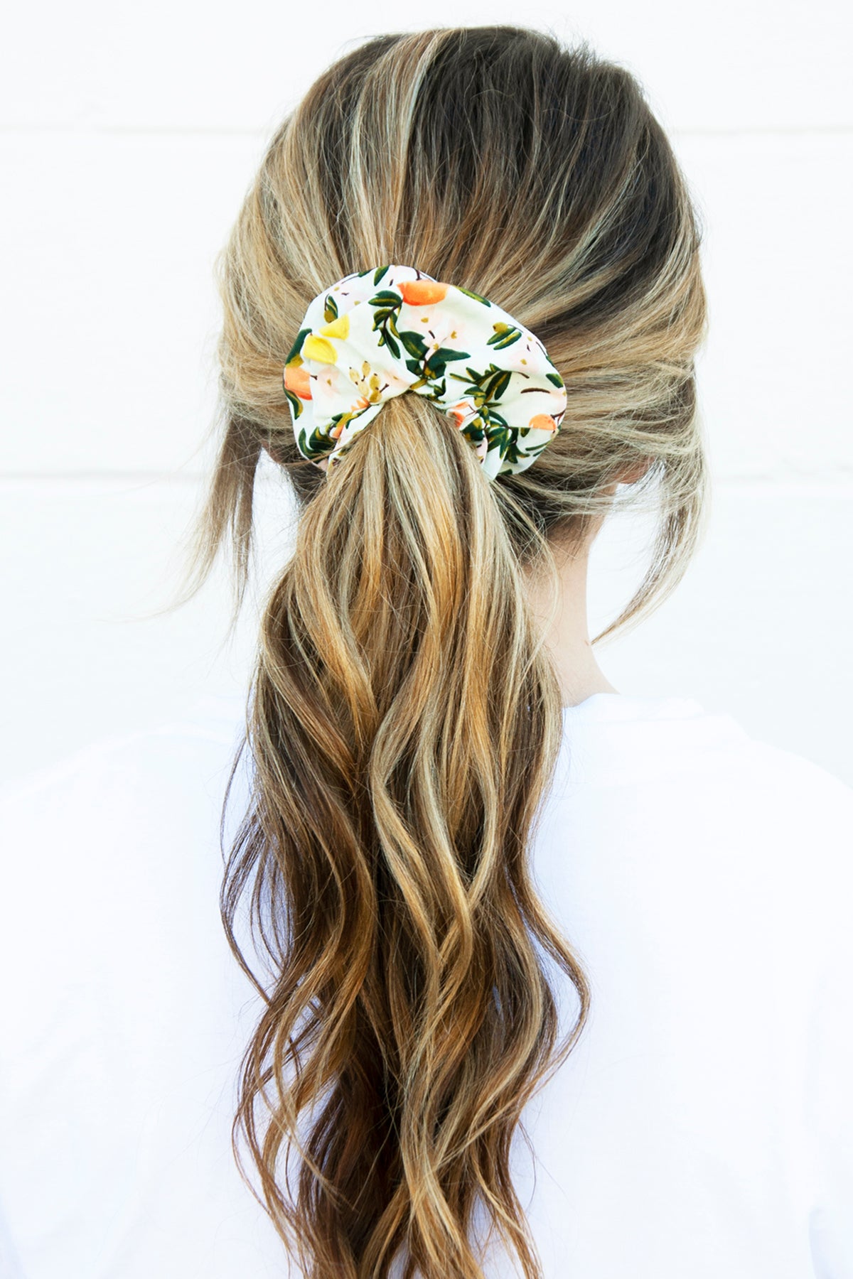 Add a squeeze of style to your ponytail with this citrus-themed scrunchie—an effortlessly cute hair accessory with tropical vibes.