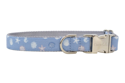 Blue nautical-print dog collar featuring shells and starfish, lined with gray webbing and finished with silver hardware.
