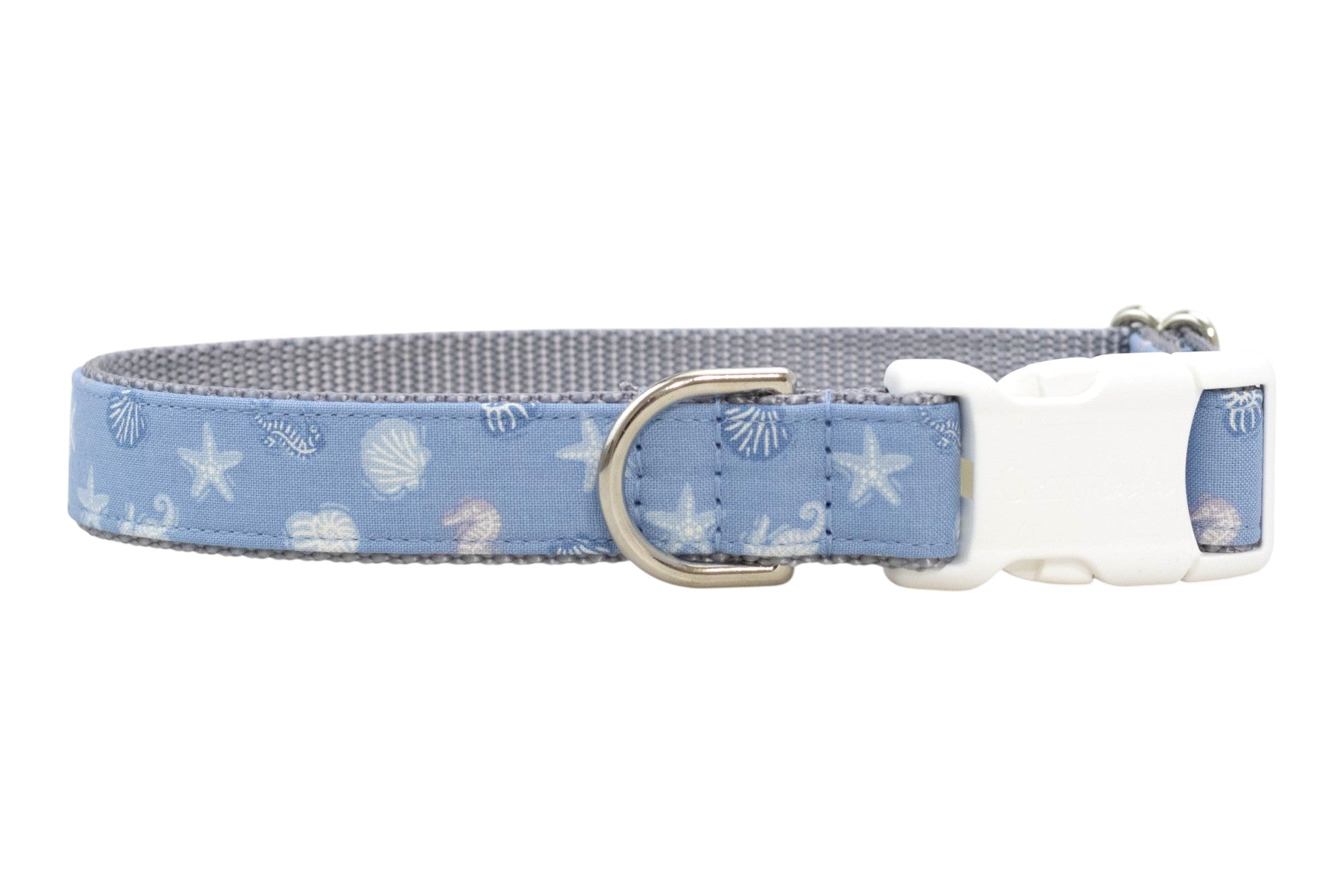 Blue nautical-print dog collar featuring shells and starfish, lined with gray webbing and finished with silver hardware and sturdy plastic buckle.