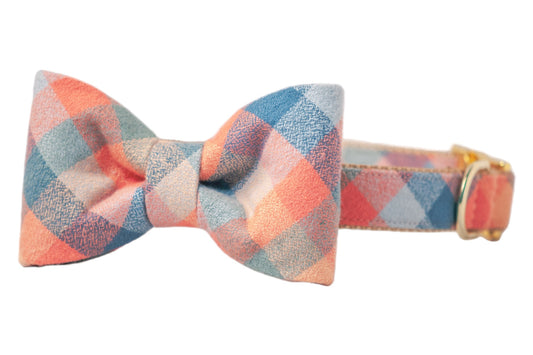 Adjustable dog collar with an attached bow tie, both covered plaid flannel fabric in muted tones, featuring hardware for size adjustment. The perfect accessory for fall!