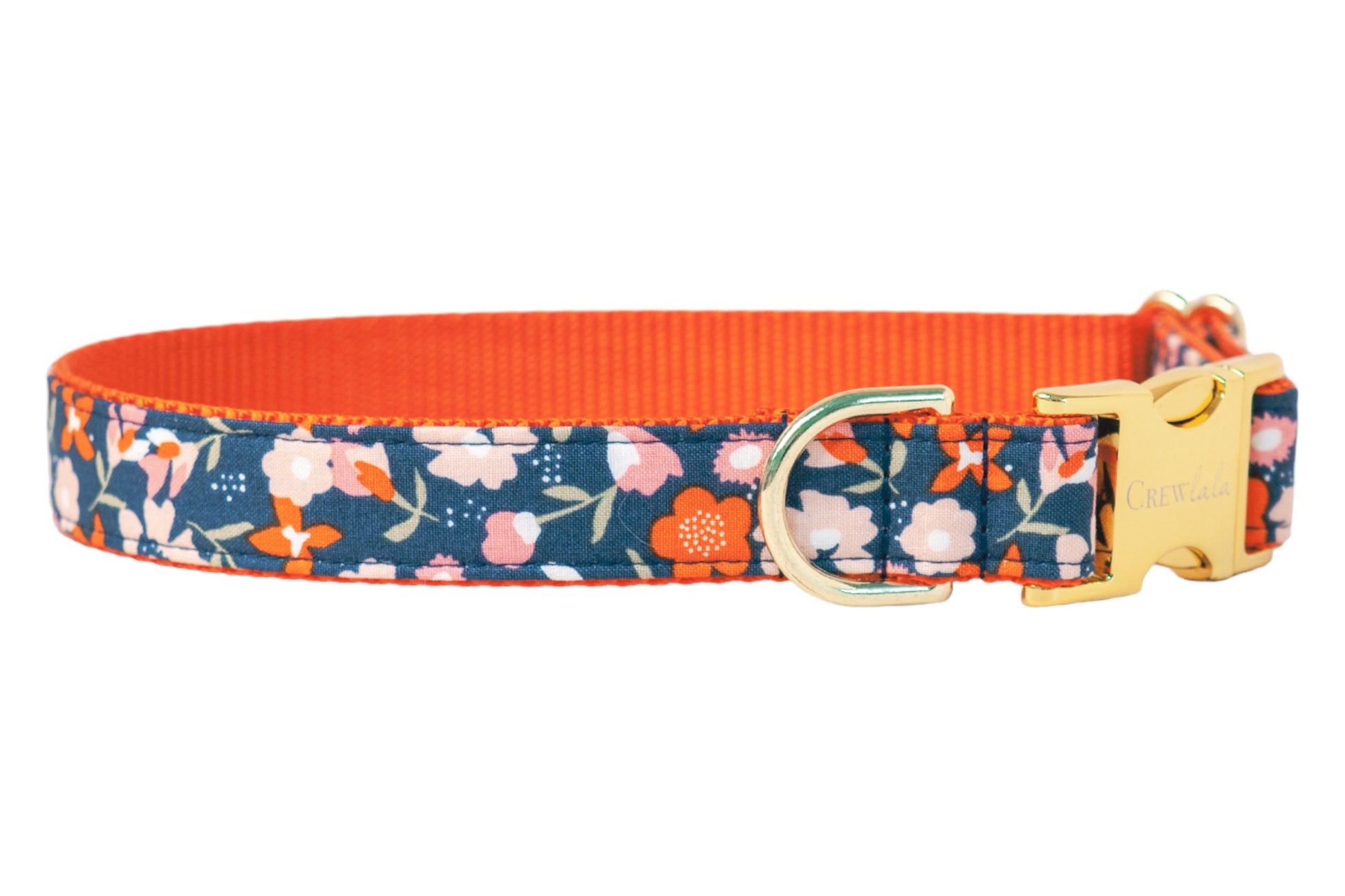 Stylish dog collar featuring a navy base with a colorful floral design of flowers connected by leafy stems. The outer fabric is sewn over durable nylon webbing, with neat stitching along the edges, and is completed with polished hardware for fastening and leash connection.