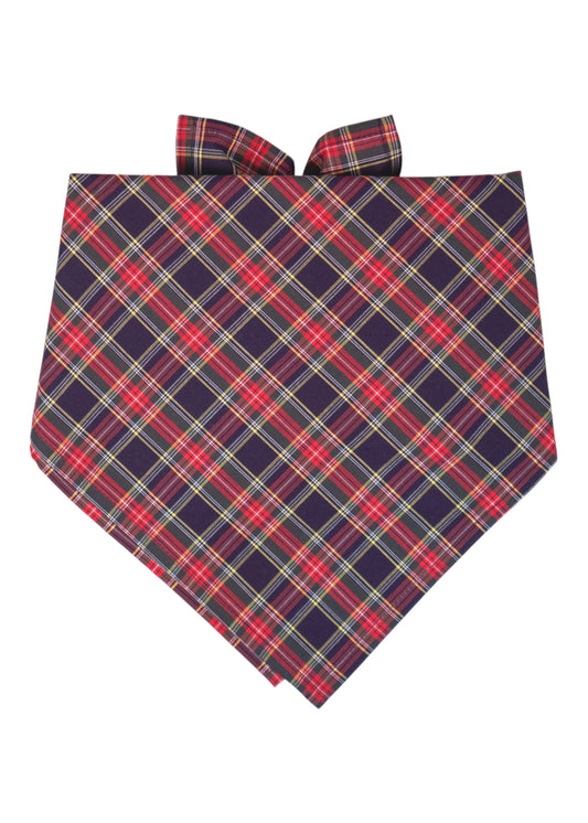 Classic tartan-patterned dog bandana with intersecting red and navy lines, folded in a pointed triangle shape and tied in a knot at the top.